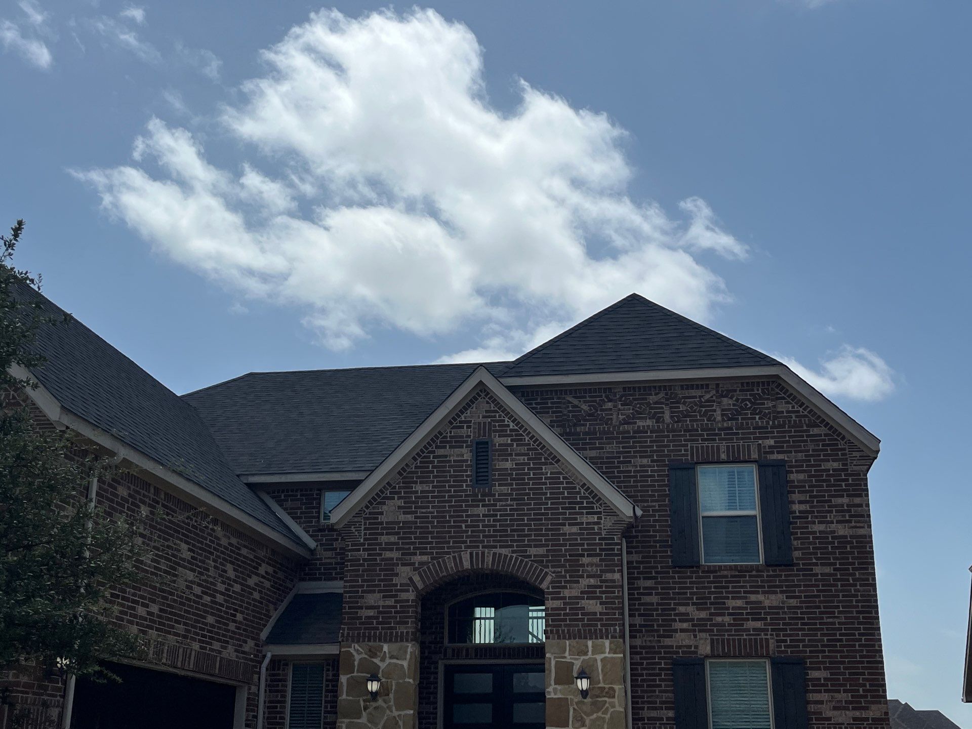 IKO Glacier-Brown Brick house by Tejas Roofworks + Restoration