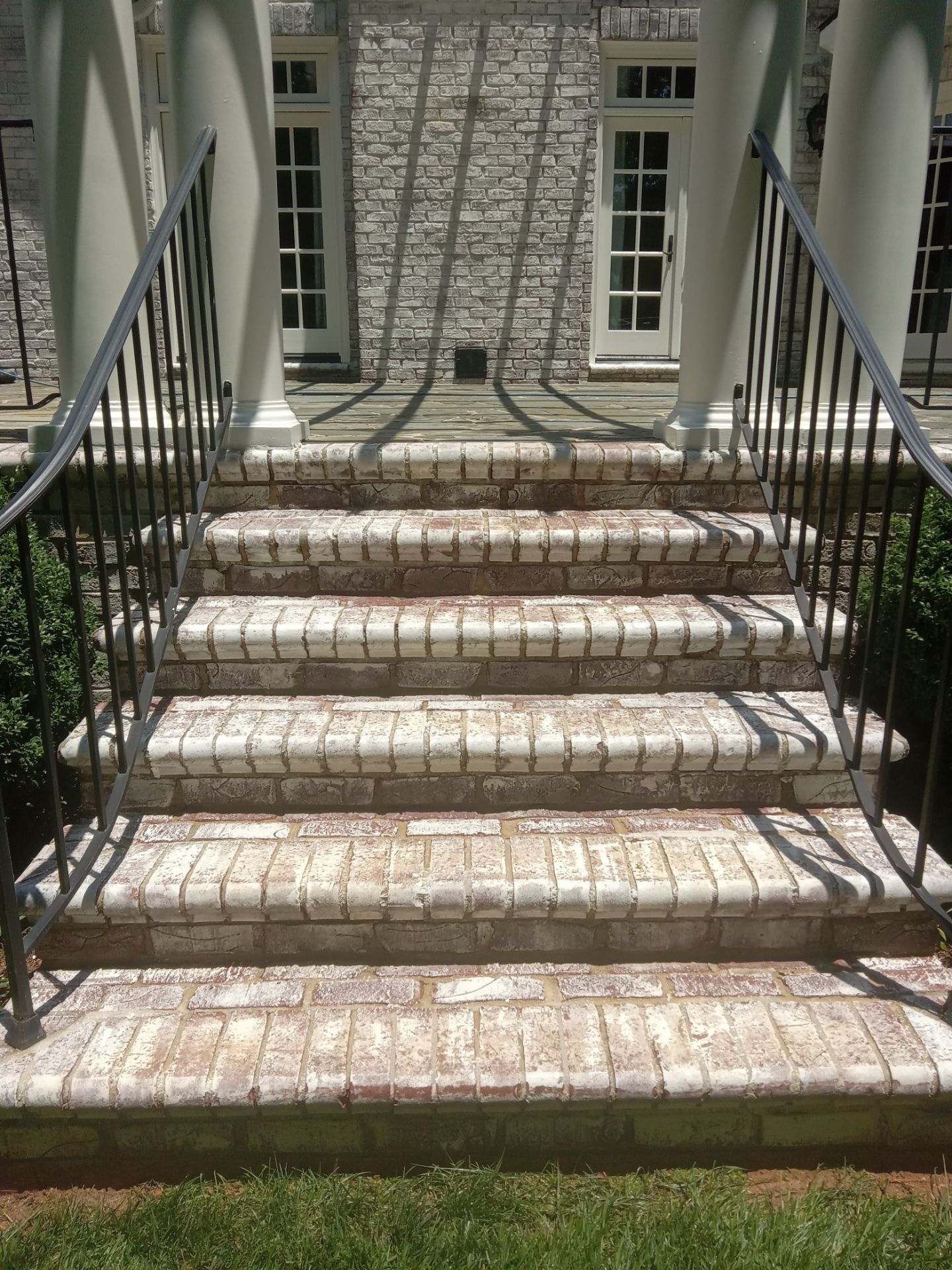 pressure washing exterior brick stairs removing dirt buildup and stains restoring original appearance of the surface