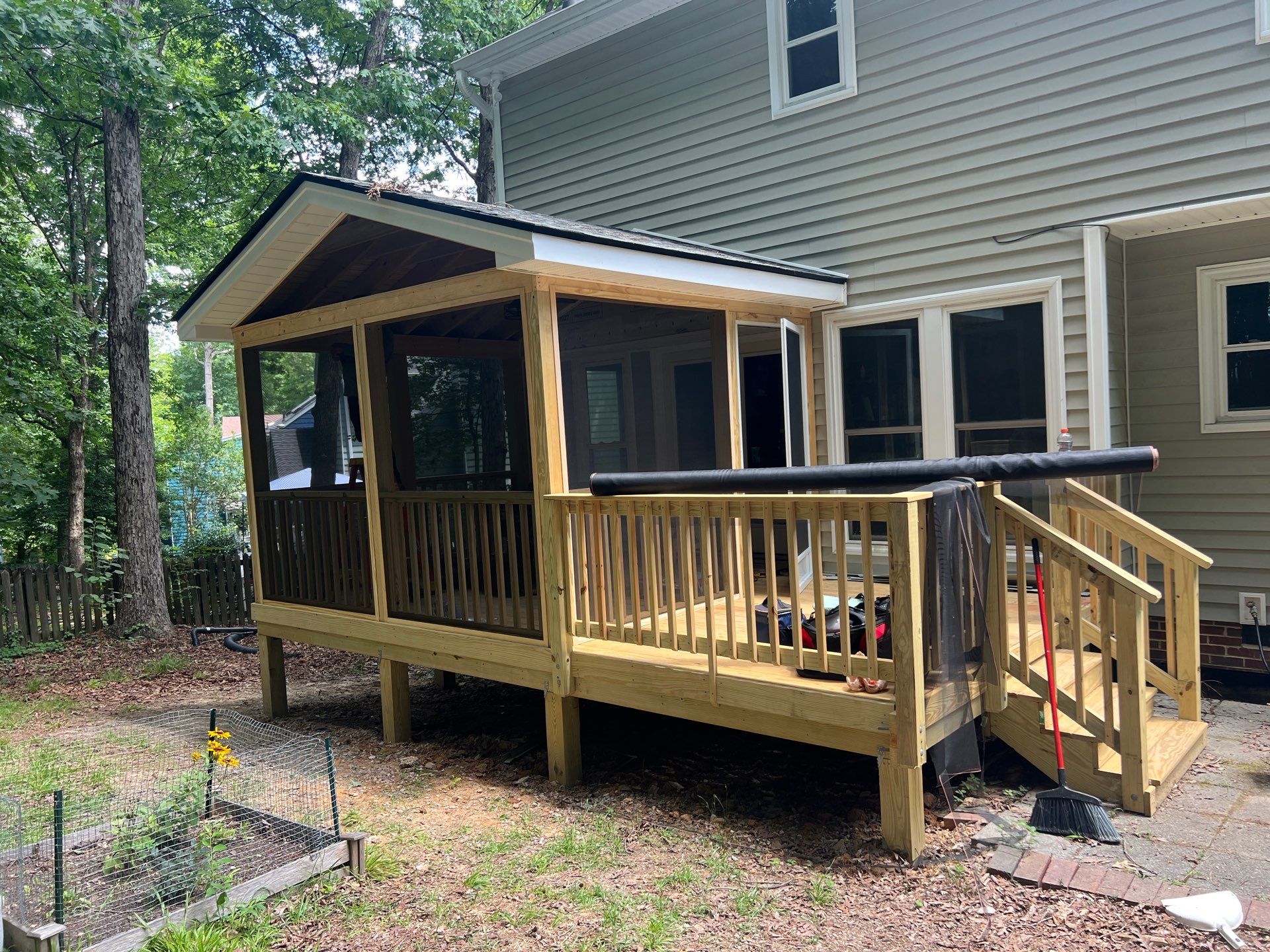 Custom Screen Porch Addition with Gabled Roof and Open Deck by The Remodeling Company