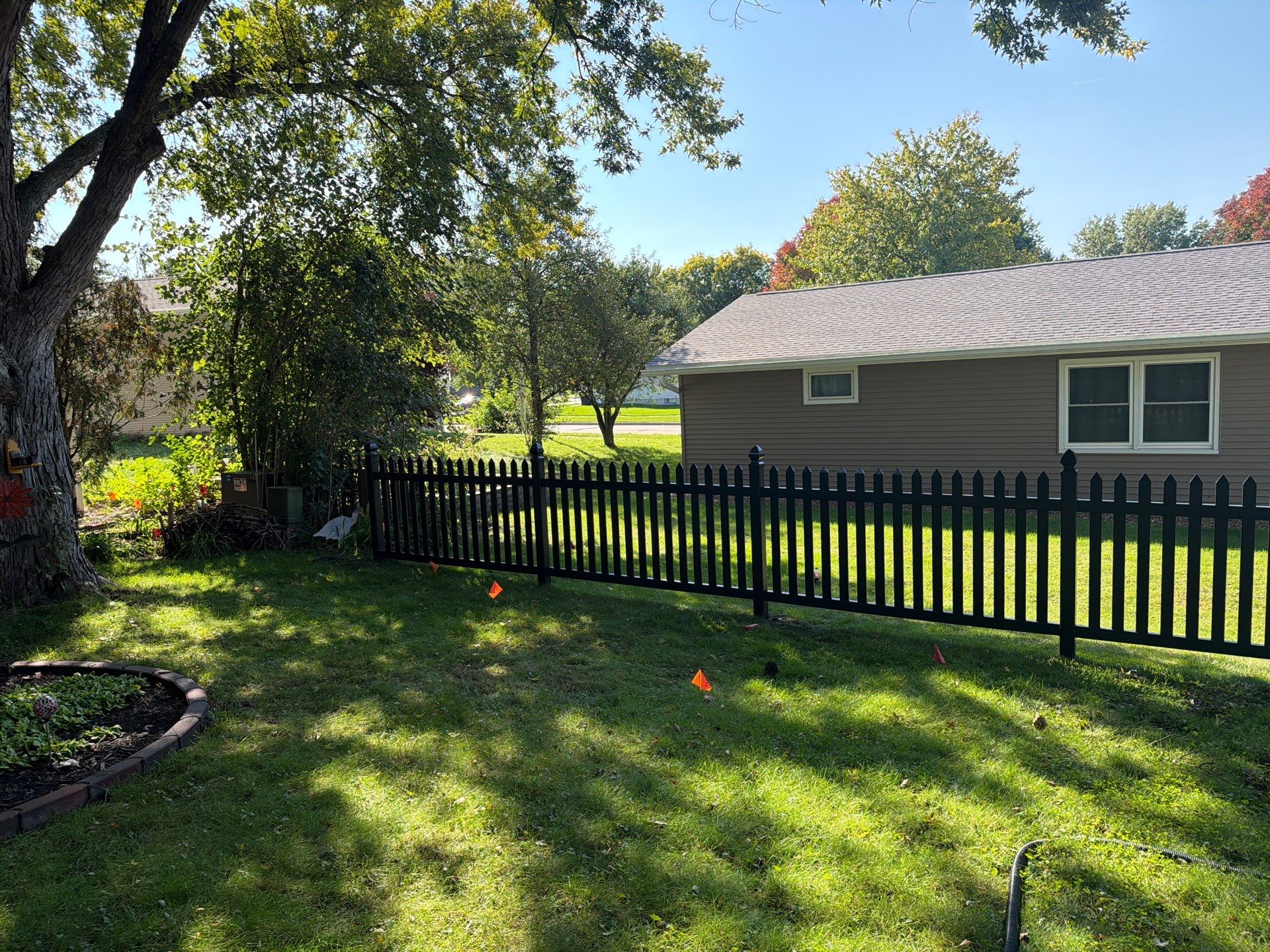 Black Vinyl Spaced Picket Fence Installation in Cedar Falls by Perfect Picket Fence and Stain