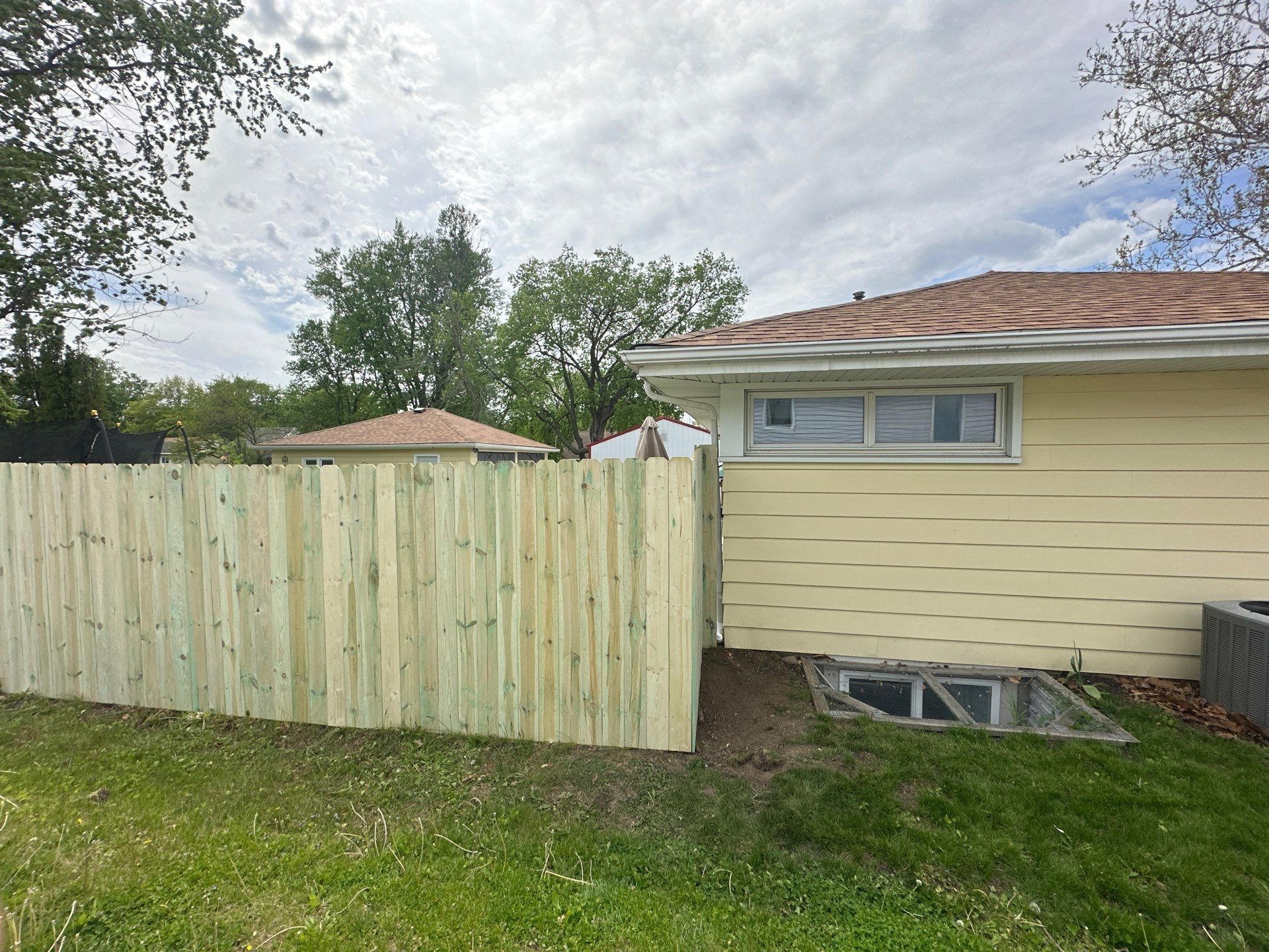 Pressure-Treated Wood Privacy Fence Installation in Waterloo by Perfect Picket Fence and Stain