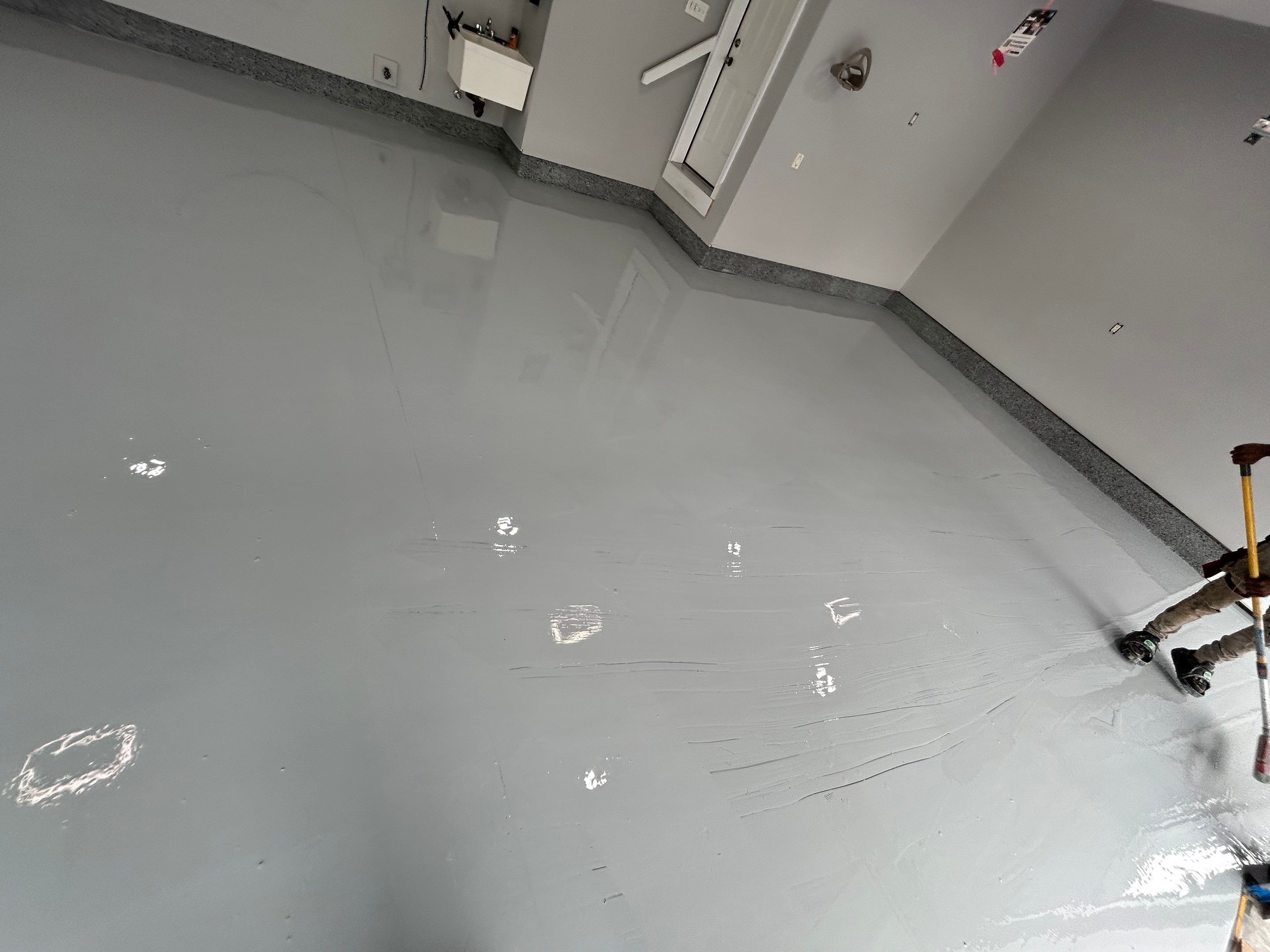 Concrete Floor Coating Transformation by DiGiorgi Roofing and Siding Inc