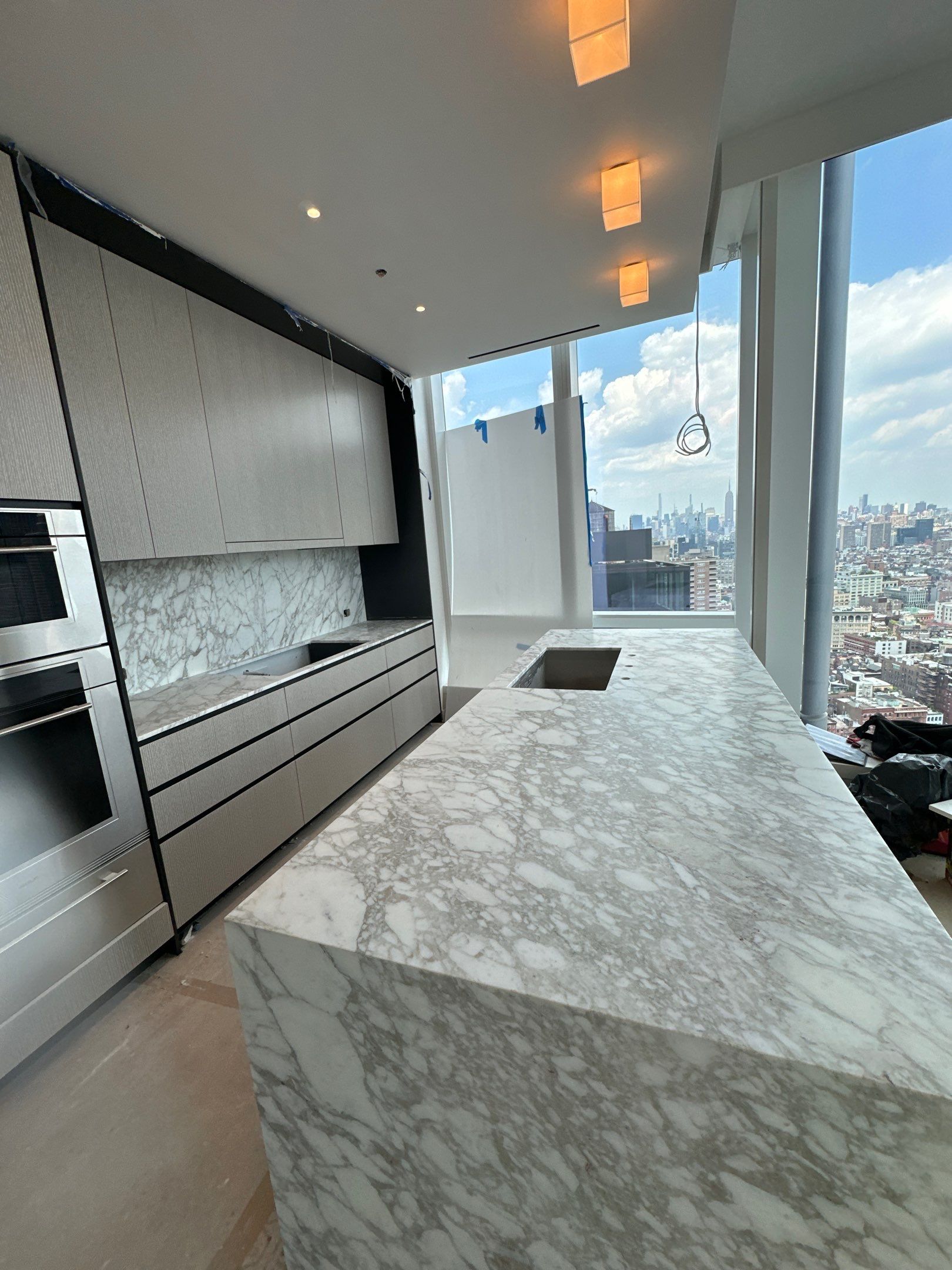 Kitchen Countertop with backsplash and Island top with mitered waterfalls by NC Stone And Tiles
