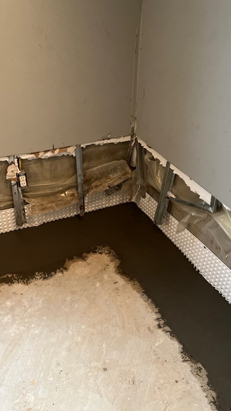 Interior drain tile system installation by ACE Waterproofing & Basement Solutions