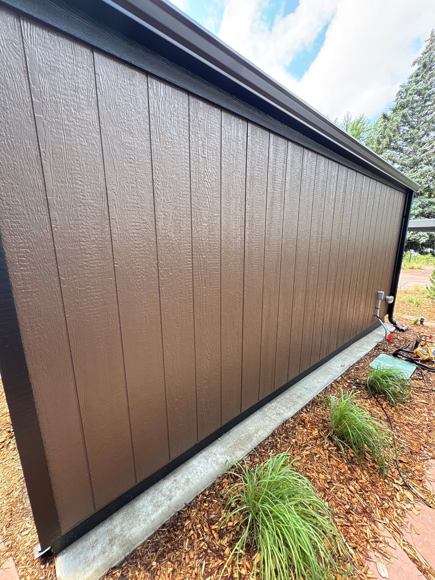 Modern Shed Construction with Stone Foundation in Sioux Falls by Select Painting, Coatings & Garage Cabinets