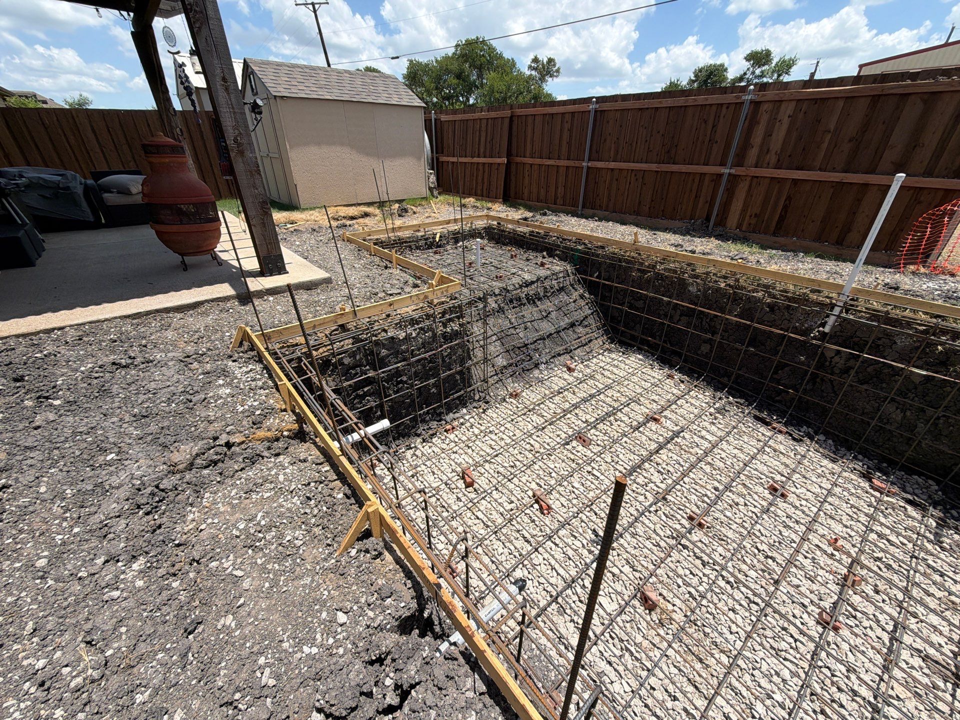Geometric Pool with Raised Stone Waterfall Wall by Pinnacle Pools and Spas - DFW