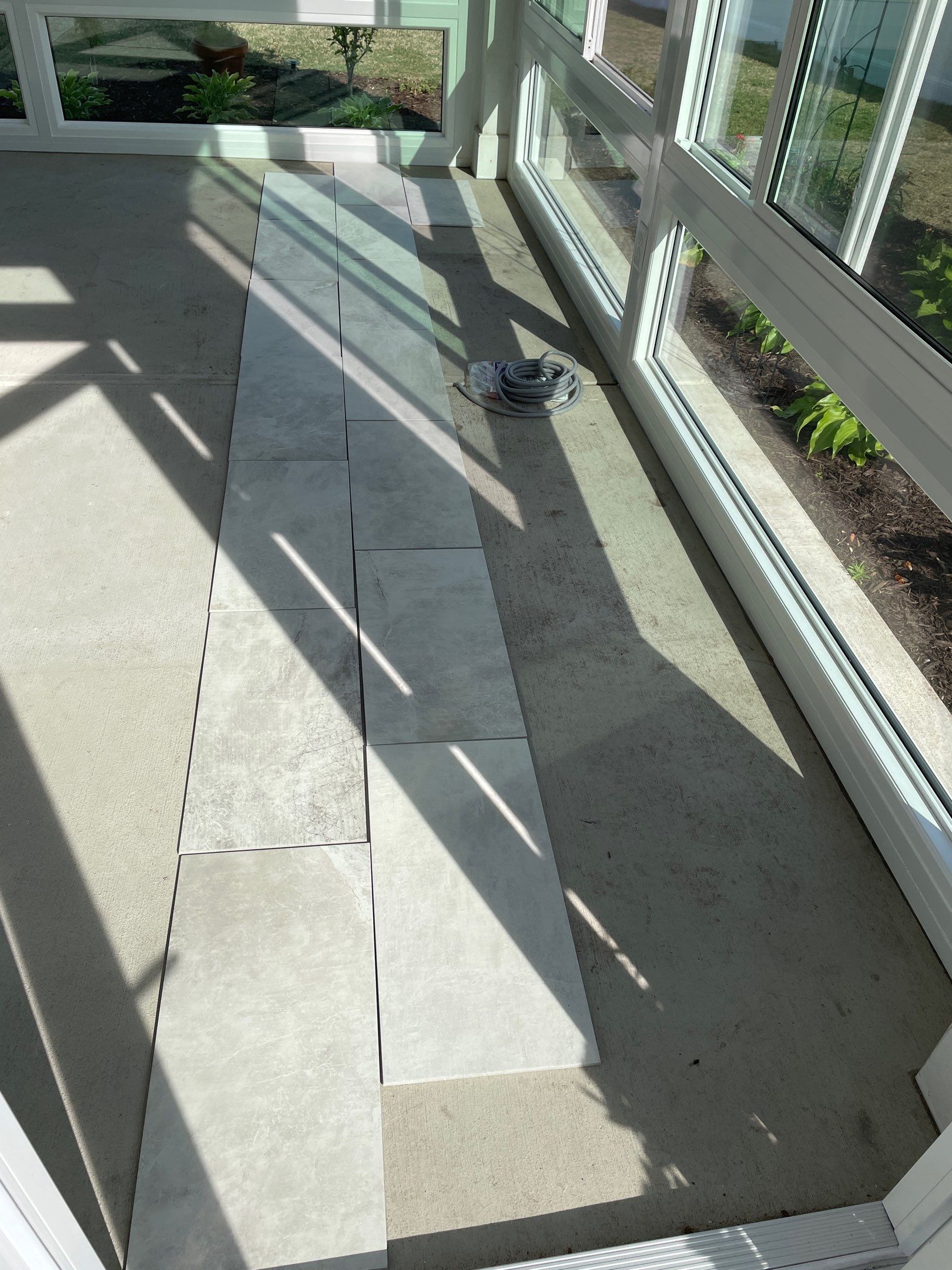 Amazing Tile Transformation After Enclosed Windows Added to Sunroom by Footprints Floors of Coastal Carolina