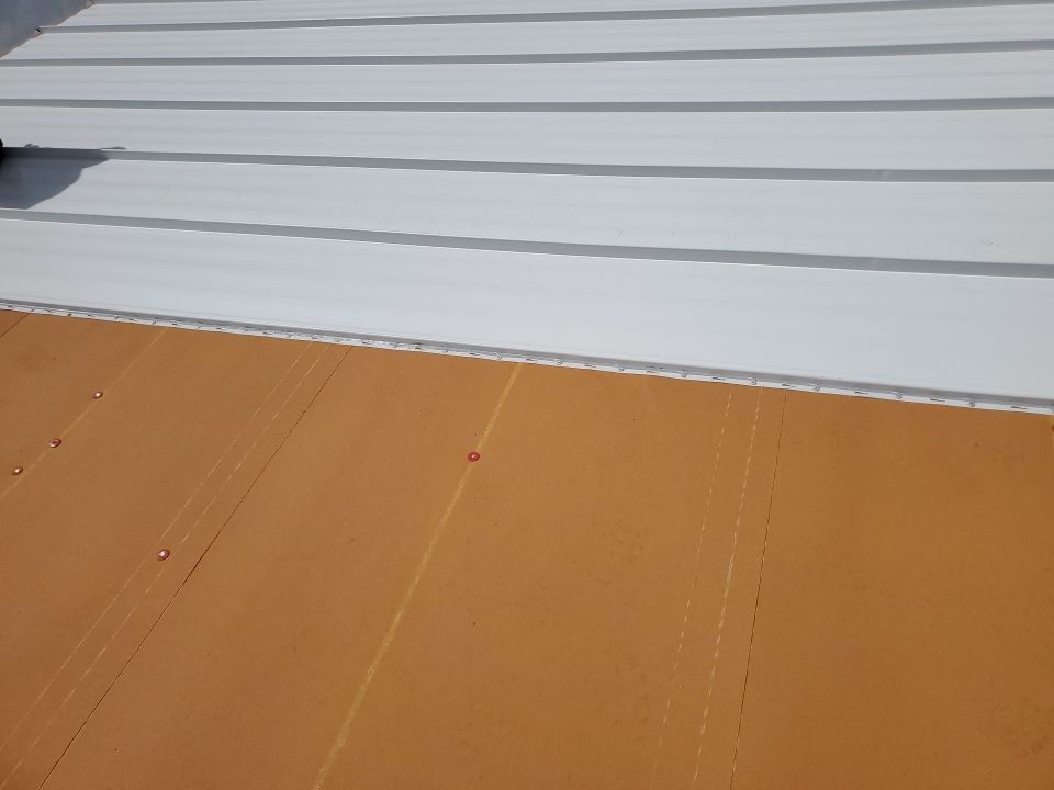 Residential Roofing Installation using 1.5" Nail Strip 24ga Solar White Kynar Coated Standing Seam Metal Panels by Morton Roofing, Inc.