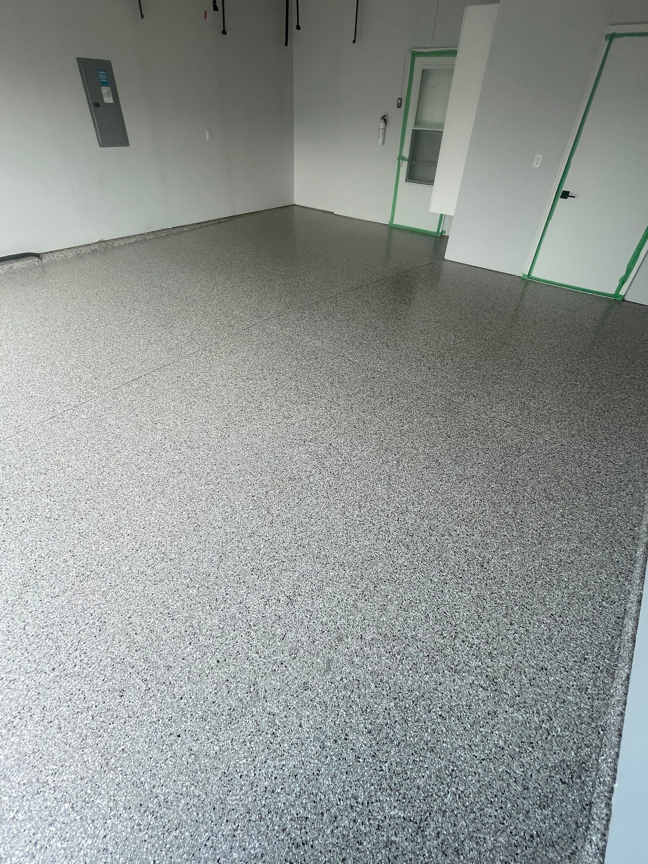 Custom Coyote Flake Garage Floor Coating in Sioux Falls by Select Painting, Coatings & Garage Cabinets