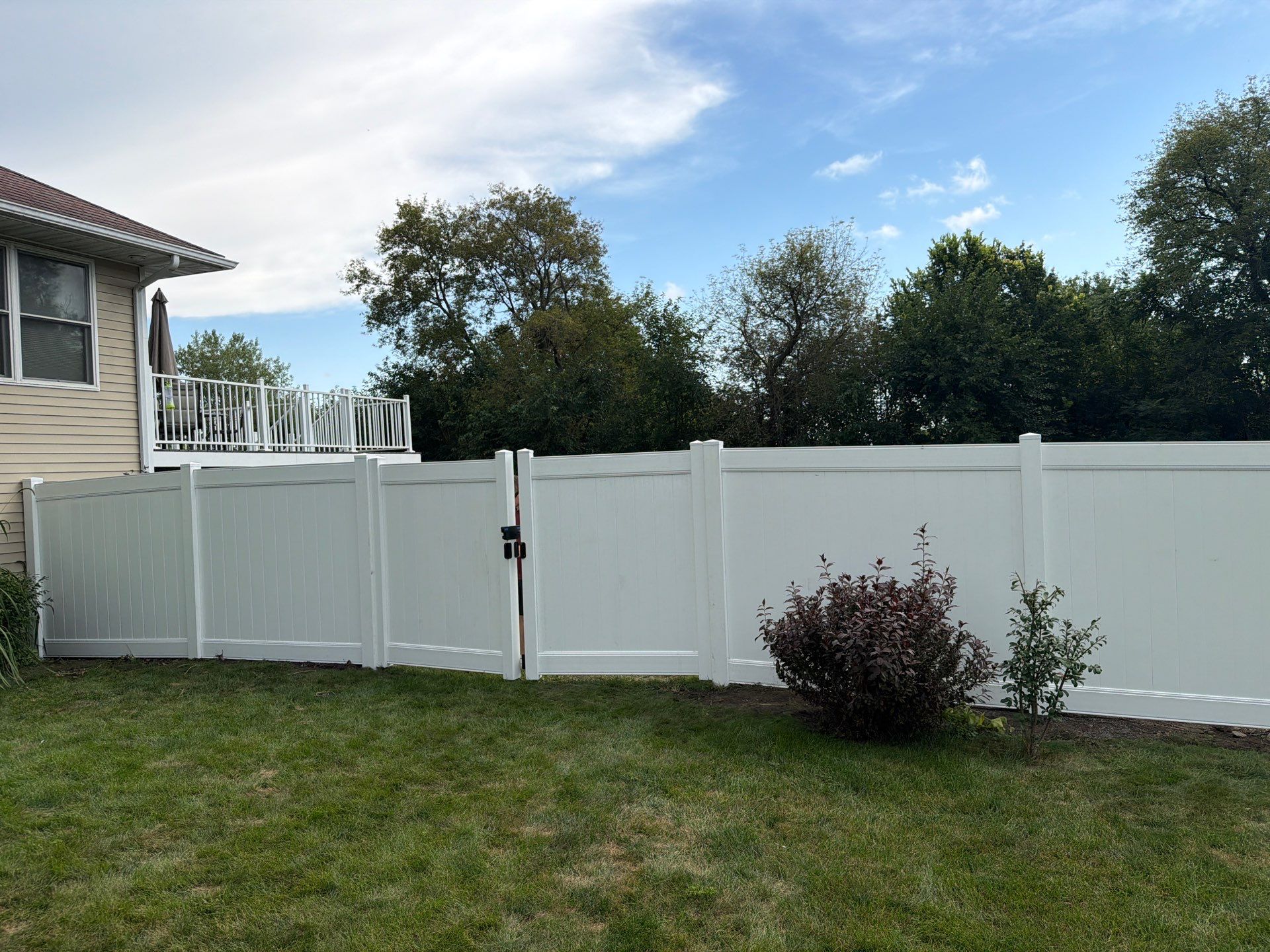 White Vinyl Privacy Fence Installation in Raymond, IA by Perfect Picket Fence and Stain