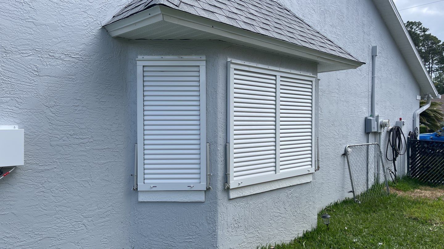 Accordion shutter and Bahama with front slide rod by Smart Guard Shutters