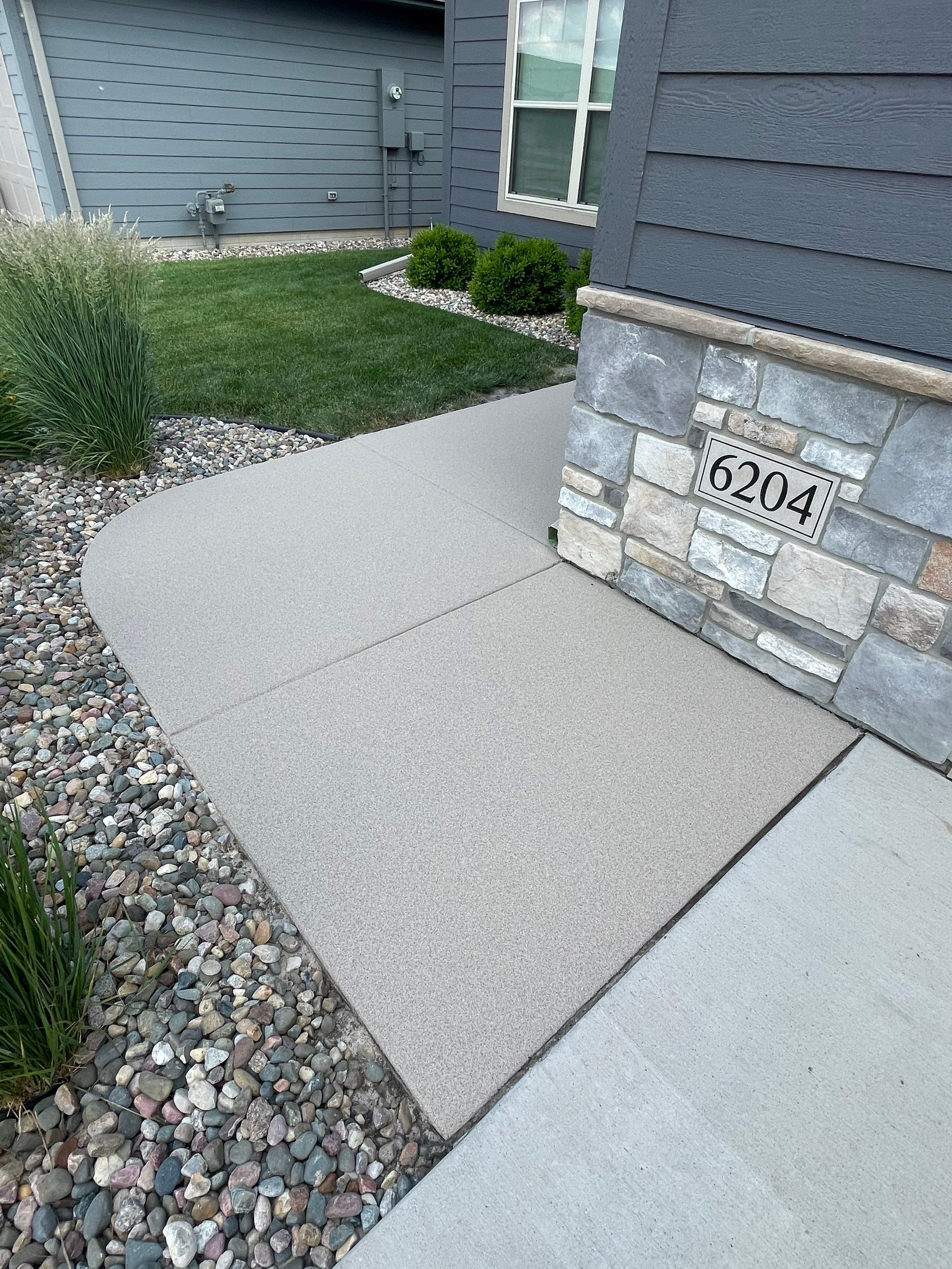 Textured Concrete Patio Coating and Custom Privacy Pergola in Sioux Falls by Select Painting, Coatings & Garage Cabinets
