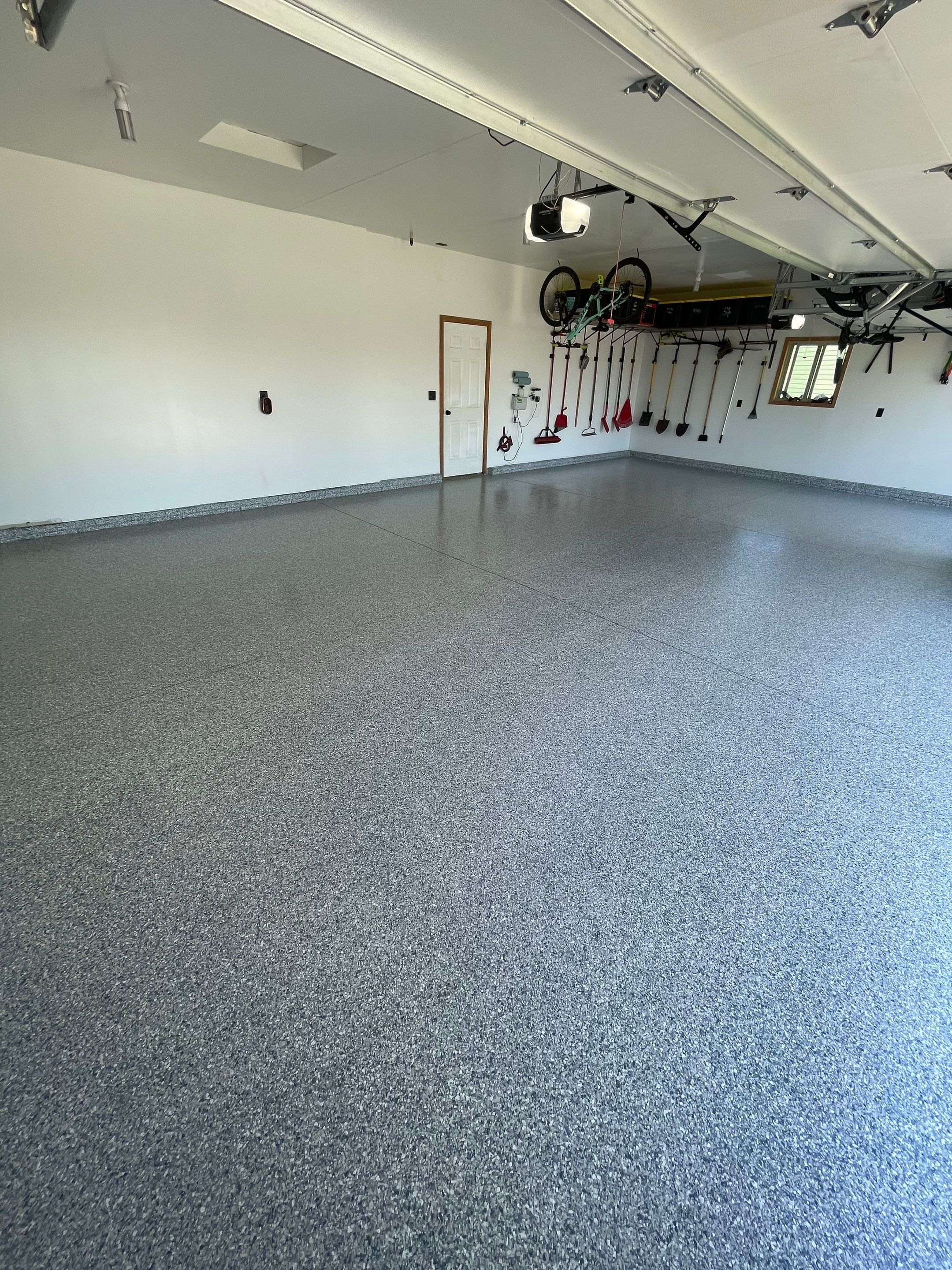 Tidal Wave Flake Garage Floor Installation in Sioux Falls by Select Painting, Coatings & Garage Cabinets