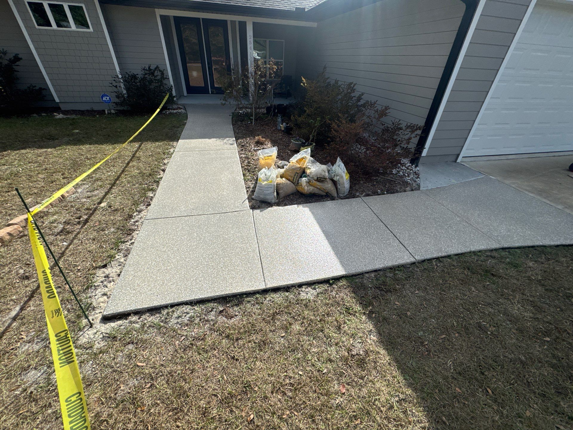 Patio and Sidewalk in Fort White, FL (Patio in Mediterranean, Sidewalk in Claystone Custom Hybrid) by Cross Creek Concrete Coatings