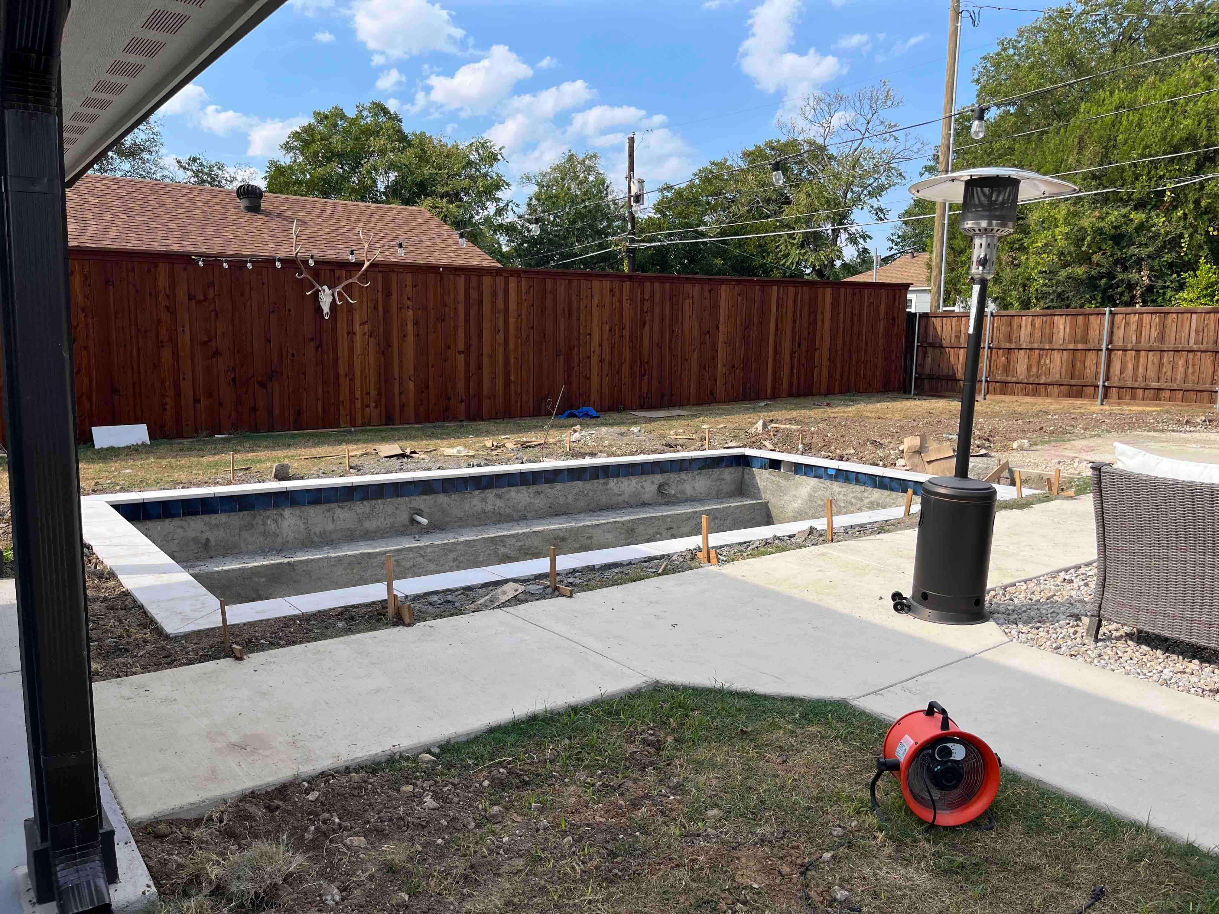 Modern Pool with Dark Interior and Deck Jets by Pinnacle Pools and Spas - DFW