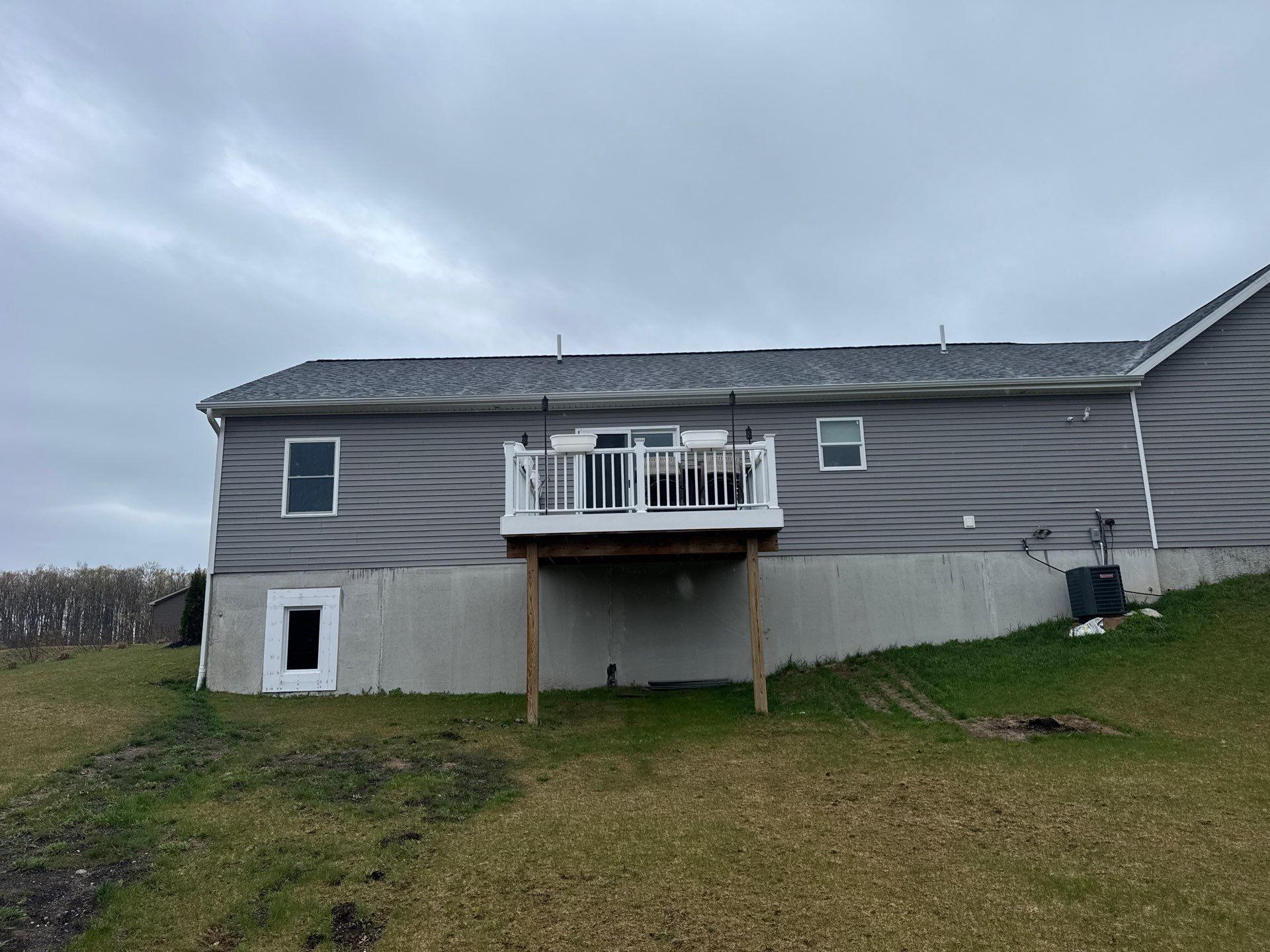 Sunesta Retractable Awning Installation Over Petoskey Home Deck by Rainbow Seamless Systems