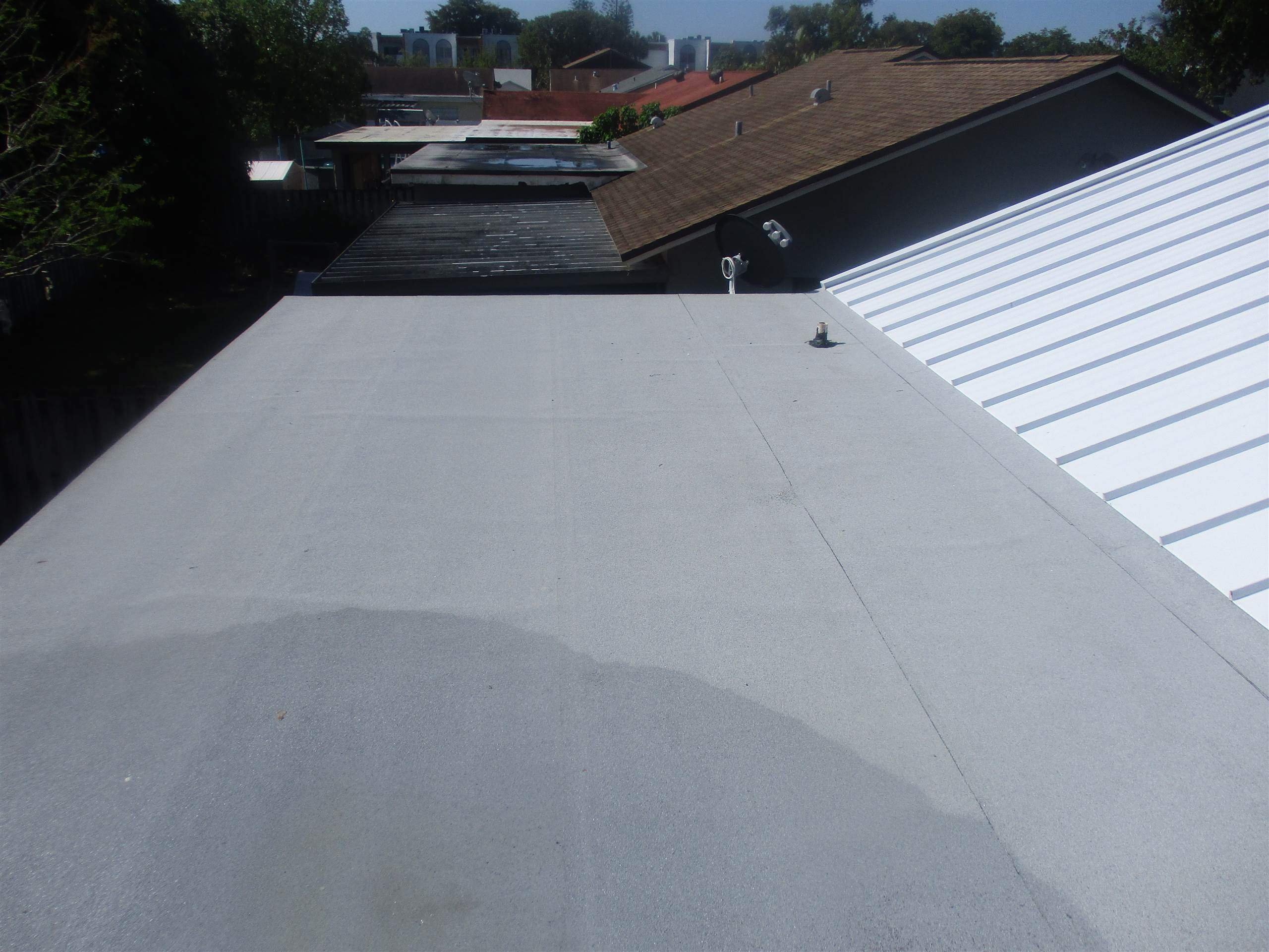 Standing Seam Metal & Flat Re-Roof using 1.5" Nail Strip 24ga Solar White Kynar Coated Standing Seam Metal Panels by Morton Roofing, Inc.
