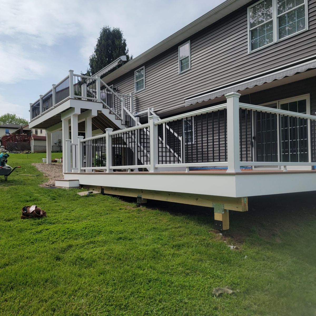 New Two Tier deck using Trex Hatteras boards and White Composite railings. by DiGiorgi Roofing and Siding Inc