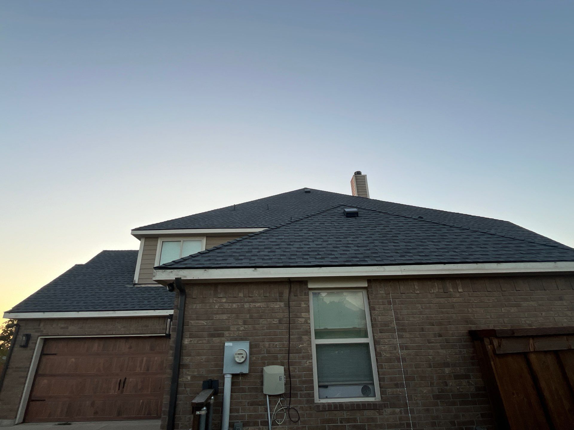 Medium brown brick with GAF Pewter Gray  by Tejas Roofworks + Restoration