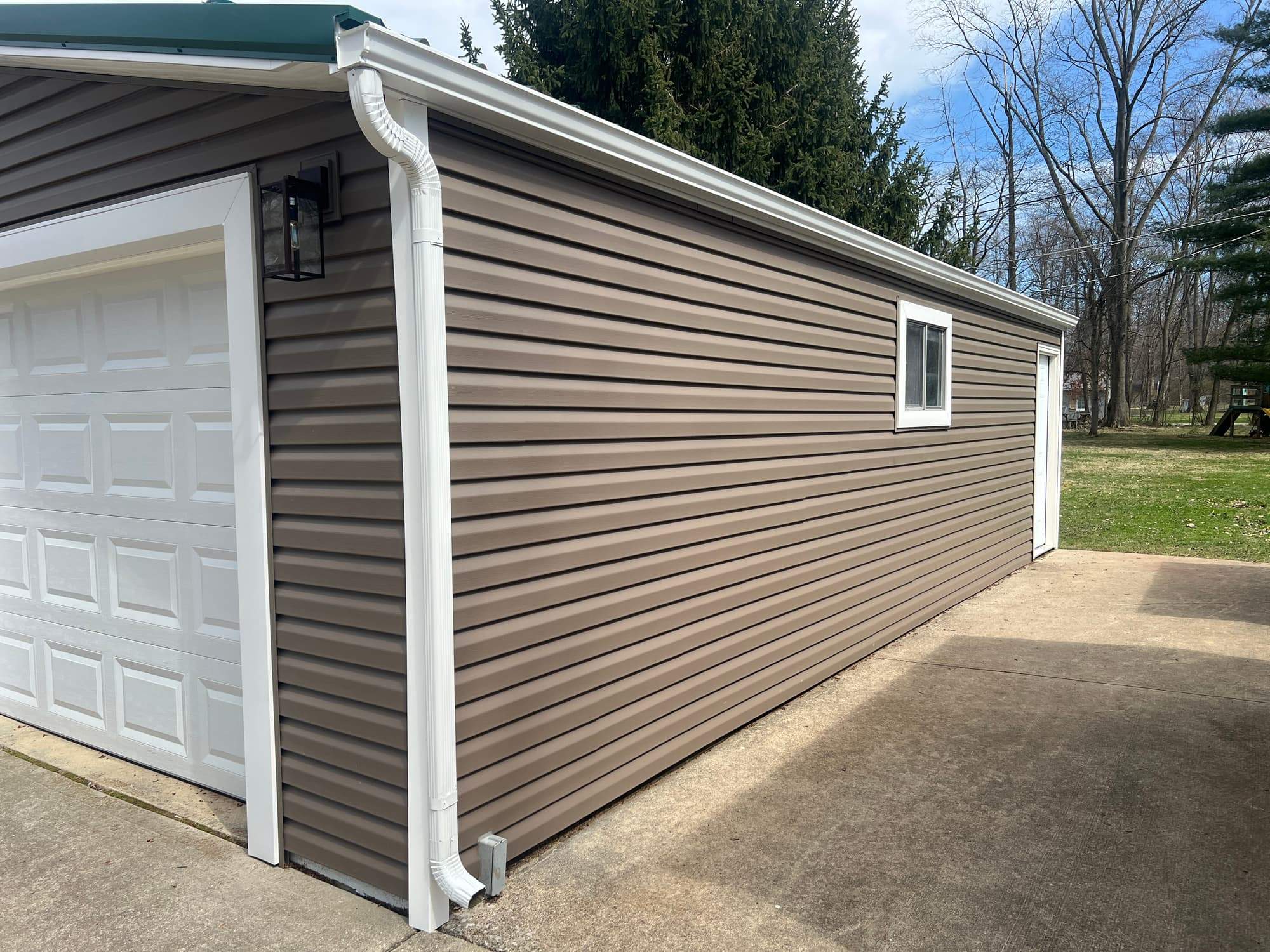 Green Metal Roof Installation and Exterior Renovation in Thornville by Canopy Contracting