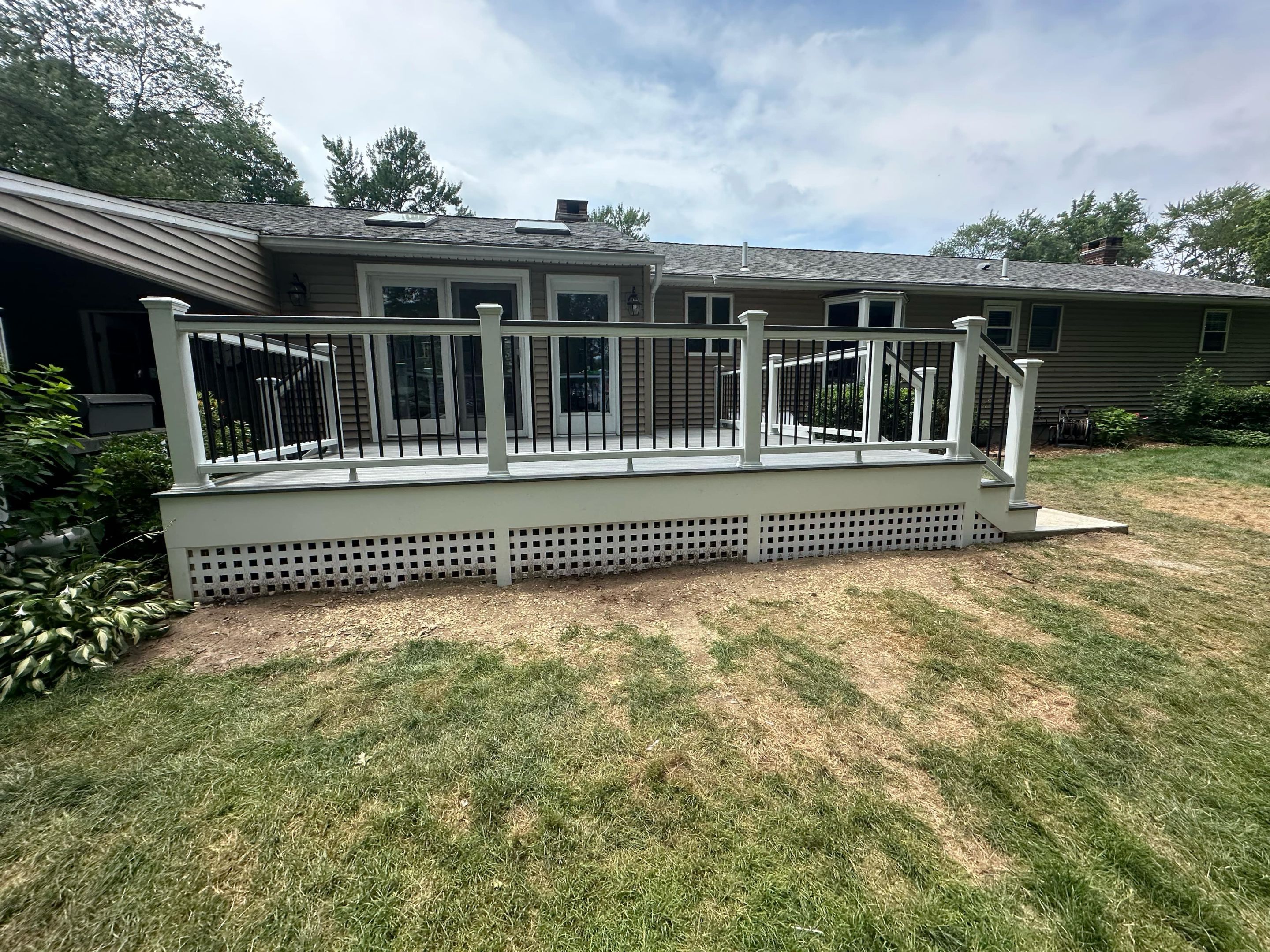 Deck Replacement with Trex Tropical Island Mist , matching cocktail rail and lattice bottom by DiGiorgi Roofing and Siding Inc