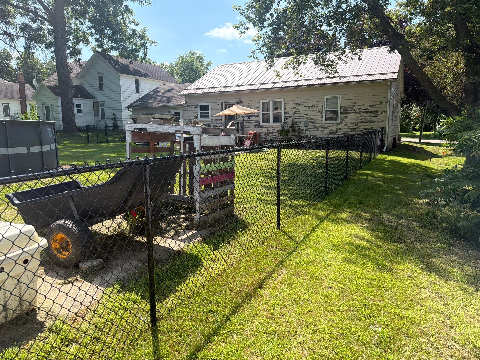 Black Chain Link Backyard Fence Installation in Tripoli, IA by Perfect Picket Fence and Stain