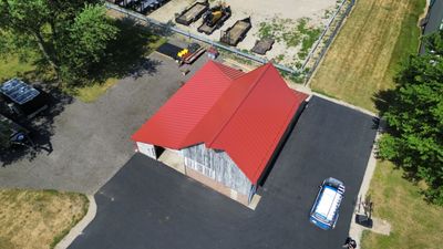 Residential Roofing Installation using Standing Seam Metal - Barn Red
