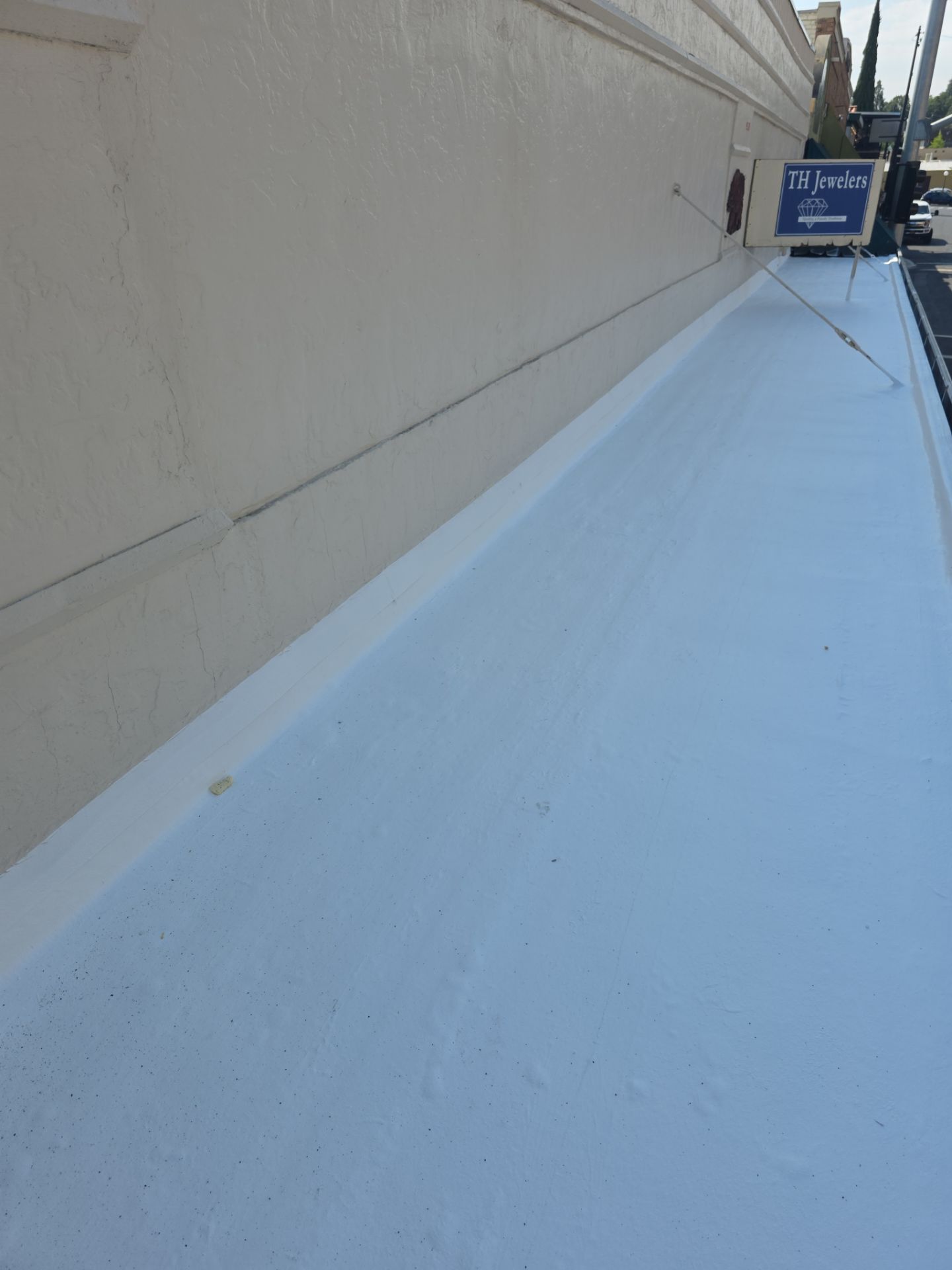 Foam and coatings on commercial roof by Straight Edge Roofing Inc