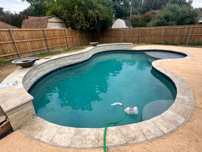 Freeform Pool with Raised Spa and Stone Decking