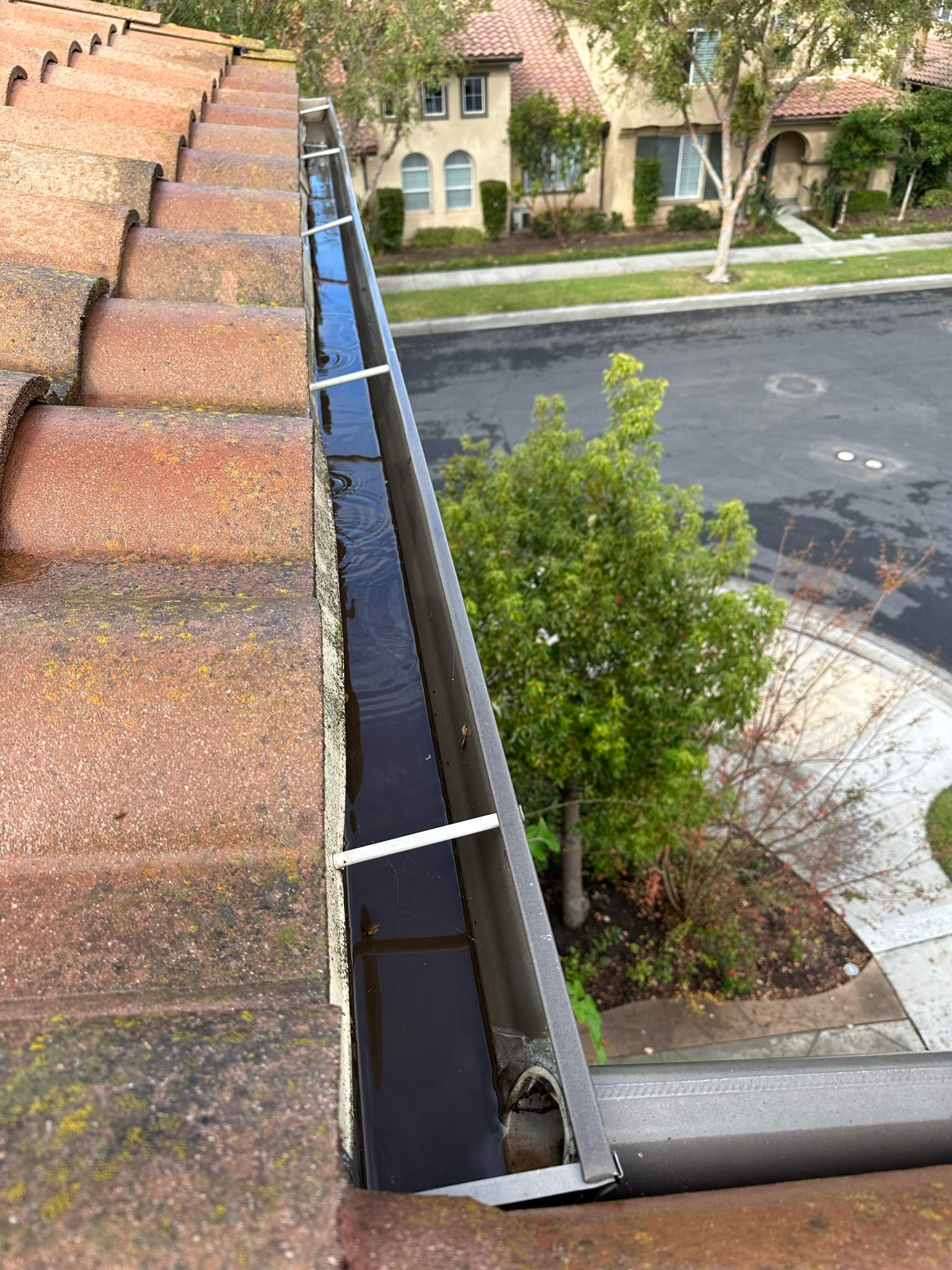 Clogged gutters at this Irvine home in Woodbury by Property Cleaning Experts