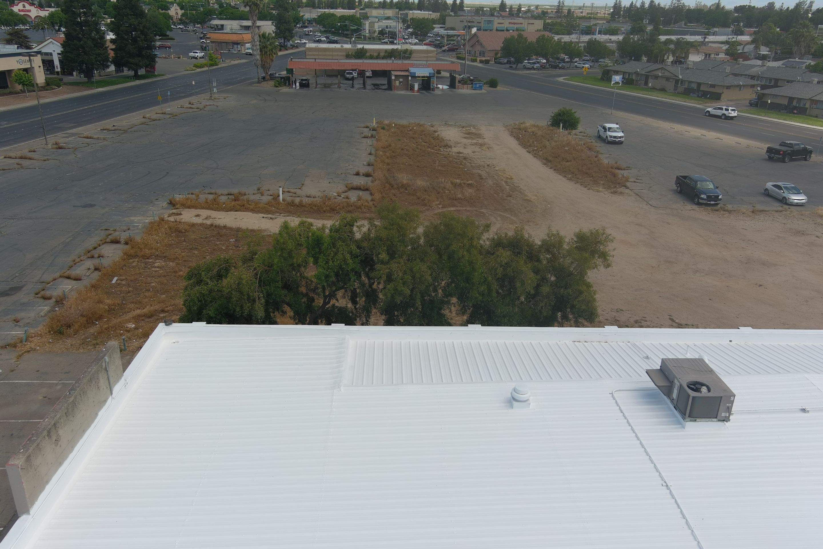 Metal roof restoration on commercial roof using Conklin Benchmark/ PUMA XL acrylic coatings over metal and foam by Straight Edge Roofing Inc