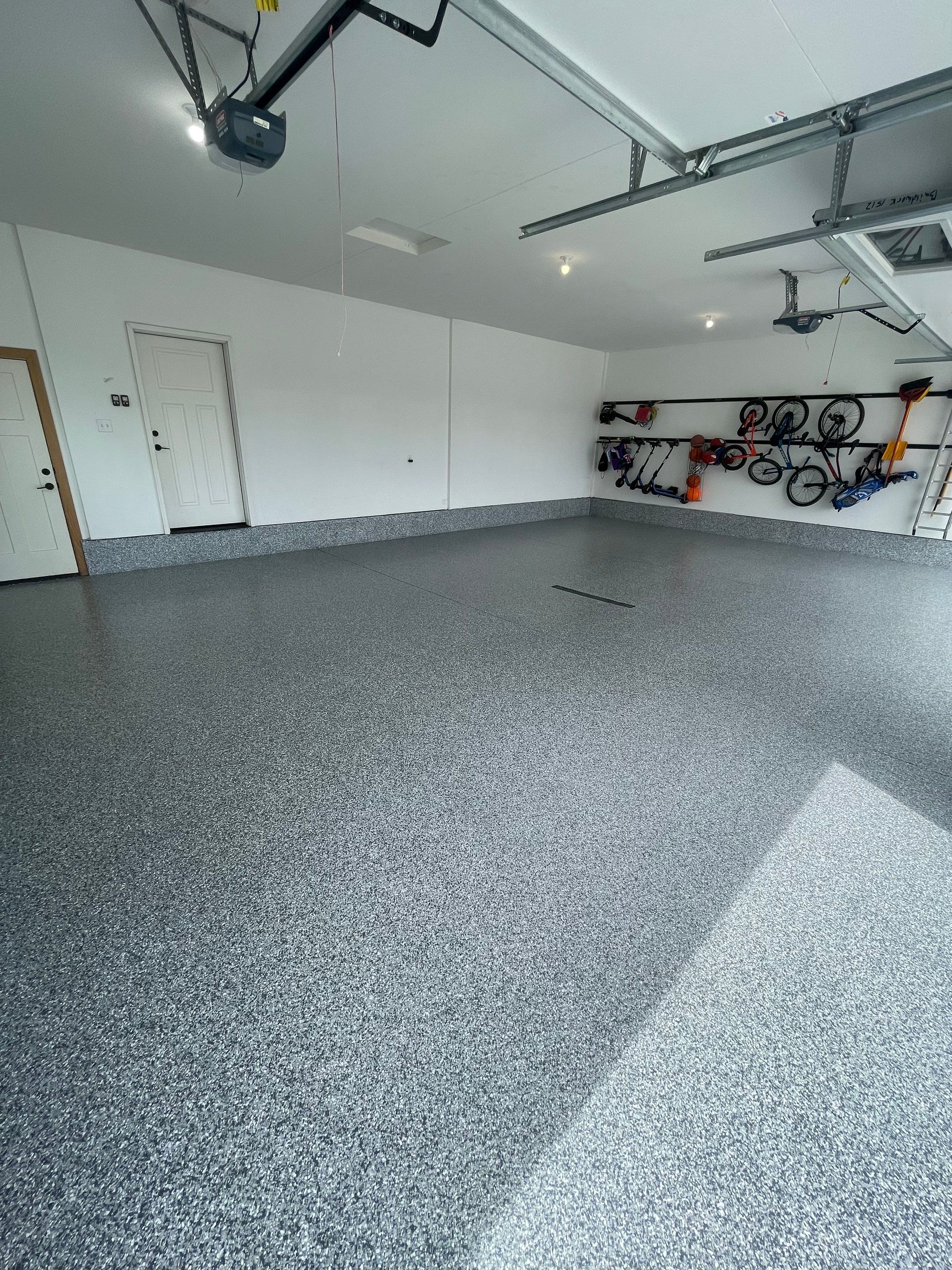 Full Garage Concrete Coating with Grey Speckled Epoxy in Brandon by Select Painting, Coatings & Garage Cabinets