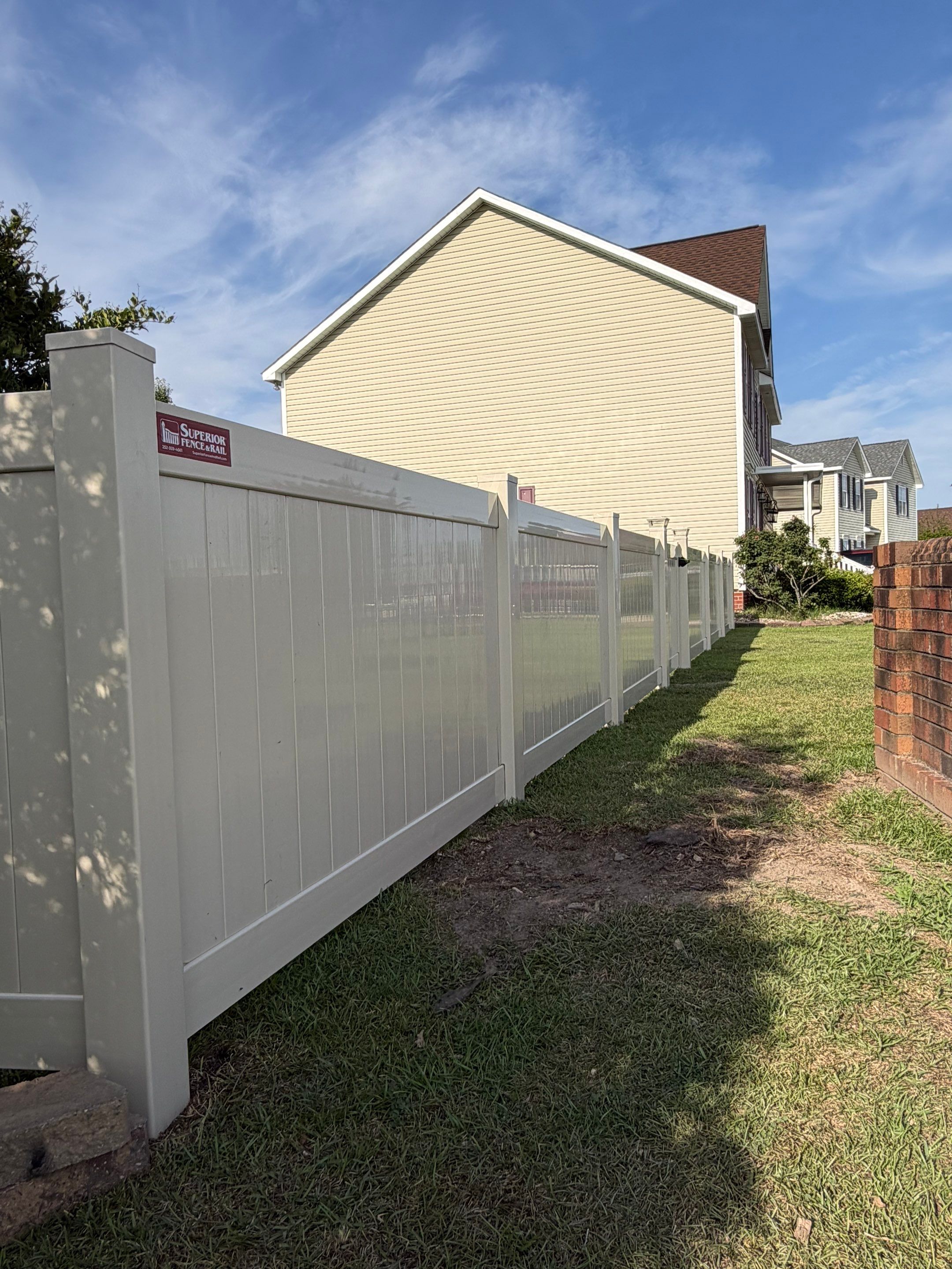 Residential Tan Vinyl Privacy Fence Installation in Winterville by Superior Fence and Rail