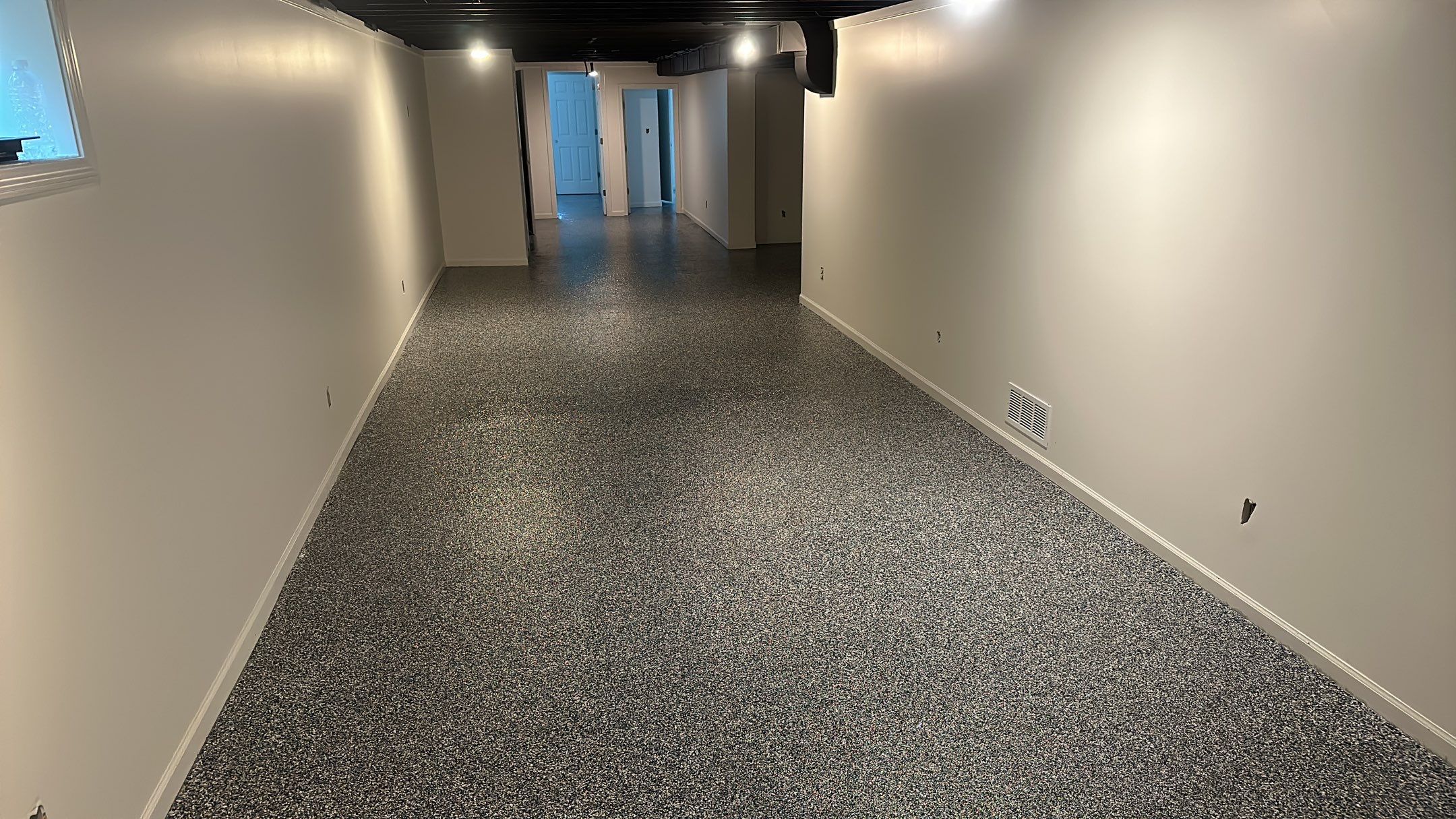 A beautiful Banner Garage Coating in a basement  by Banner Garage