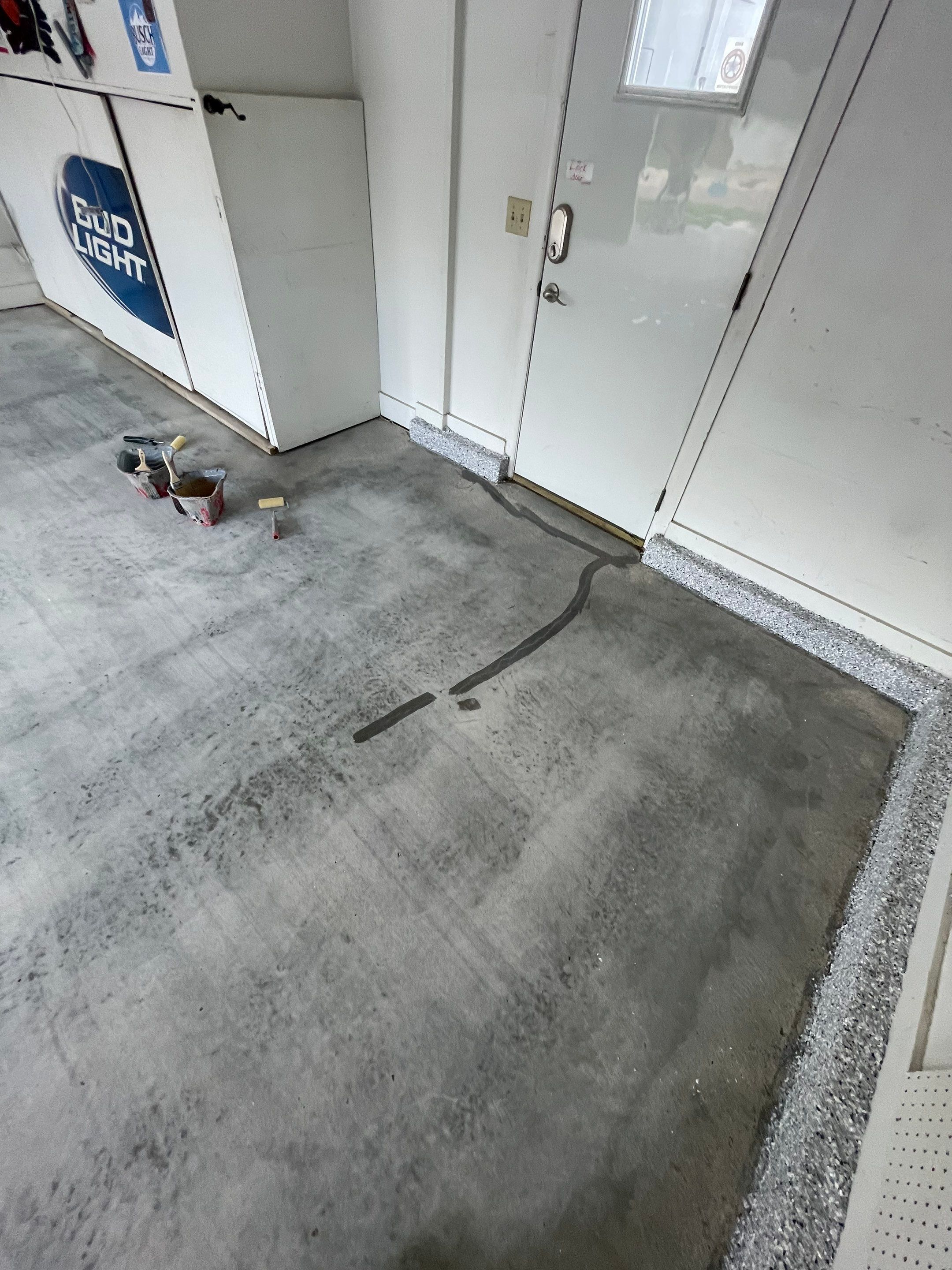 Residential Garage Floor Coating with Feather Grey Finish in Sioux Falls by Select Painting, Coatings & Garage Cabinets