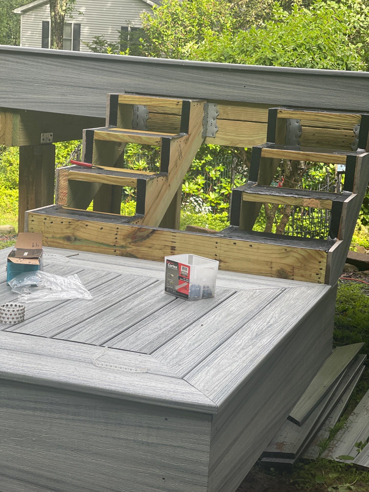 Raised Gray Composite Deck and Staircase Construction in Pocono Summit, PA by Herts Roofing & Construction