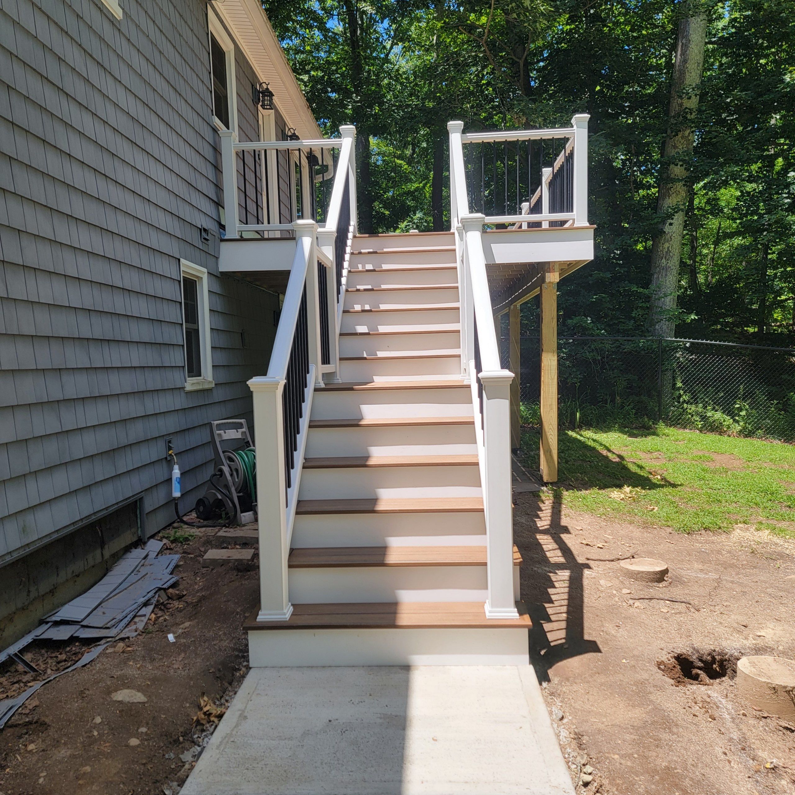 Deck replacement using trex tropical Havana Gold and transcend white railings by DiGiorgi Roofing and Siding Inc