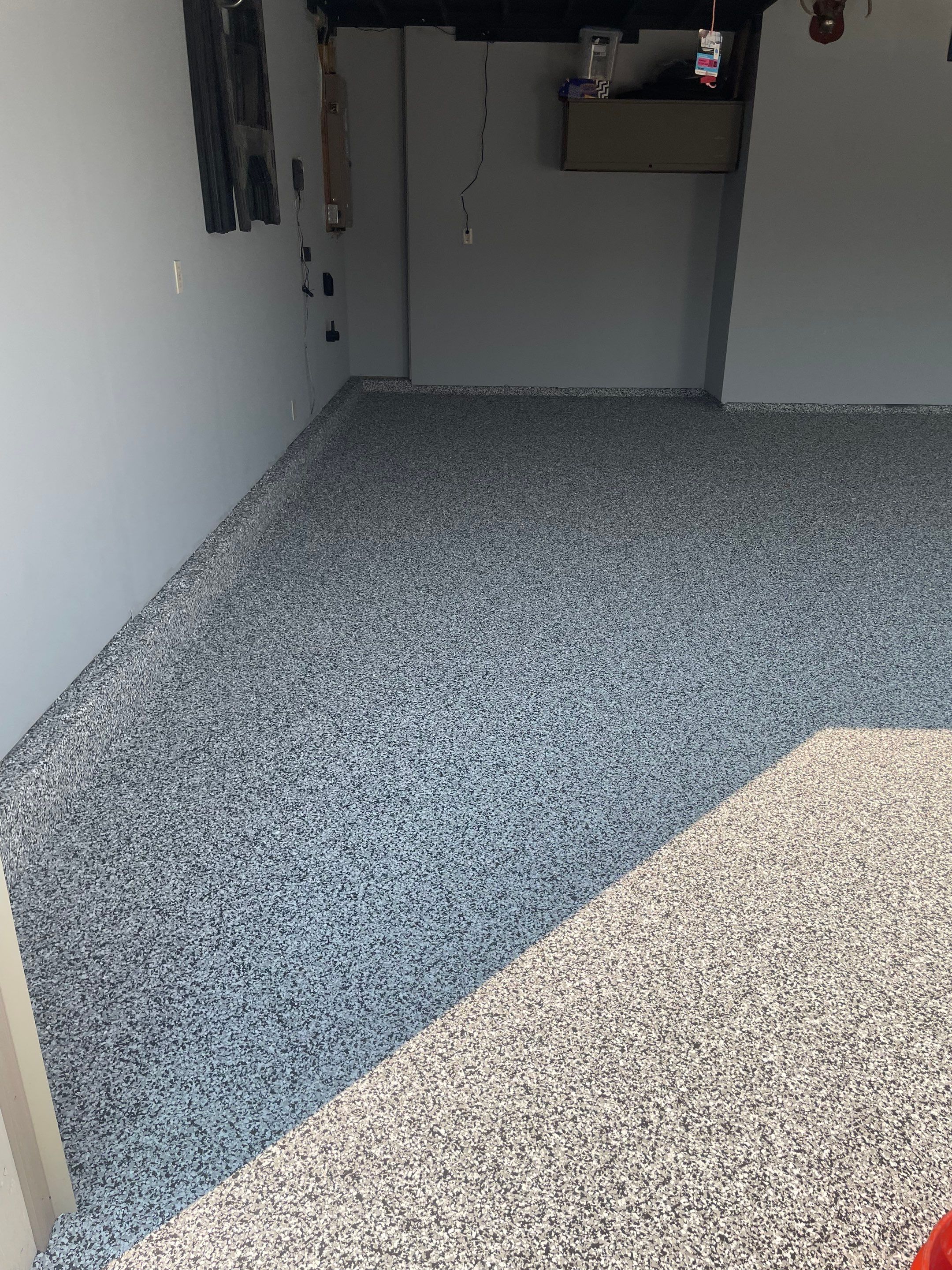 Sioux Falls Garage Concrete Coating Installation with Domino Flake by Select Painting, Coatings & Garage Cabinets