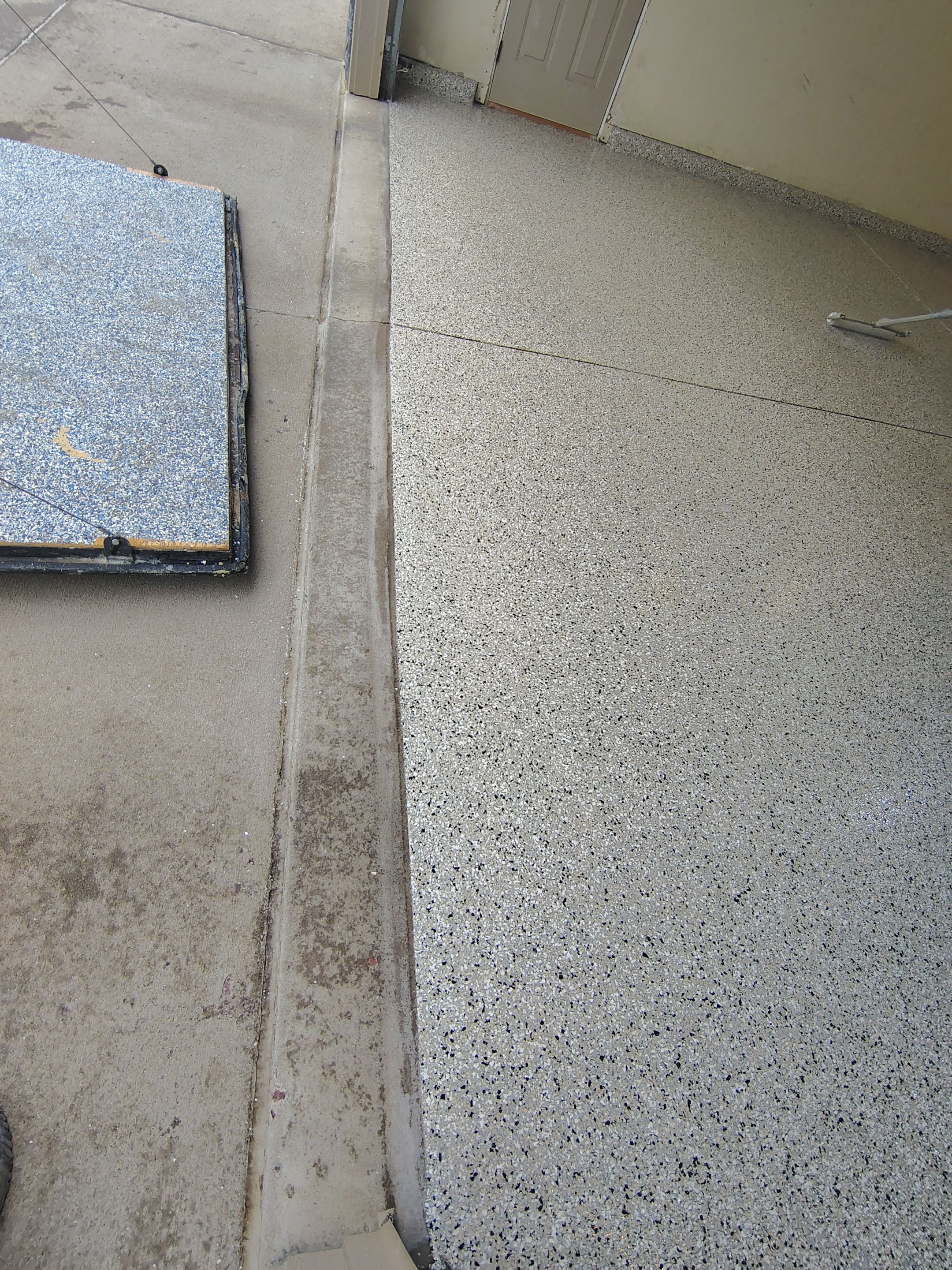Sioux Falls Garage Floor Repair and Speckled Epoxy Coating Installation by Select Painting, Coatings & Garage Cabinets