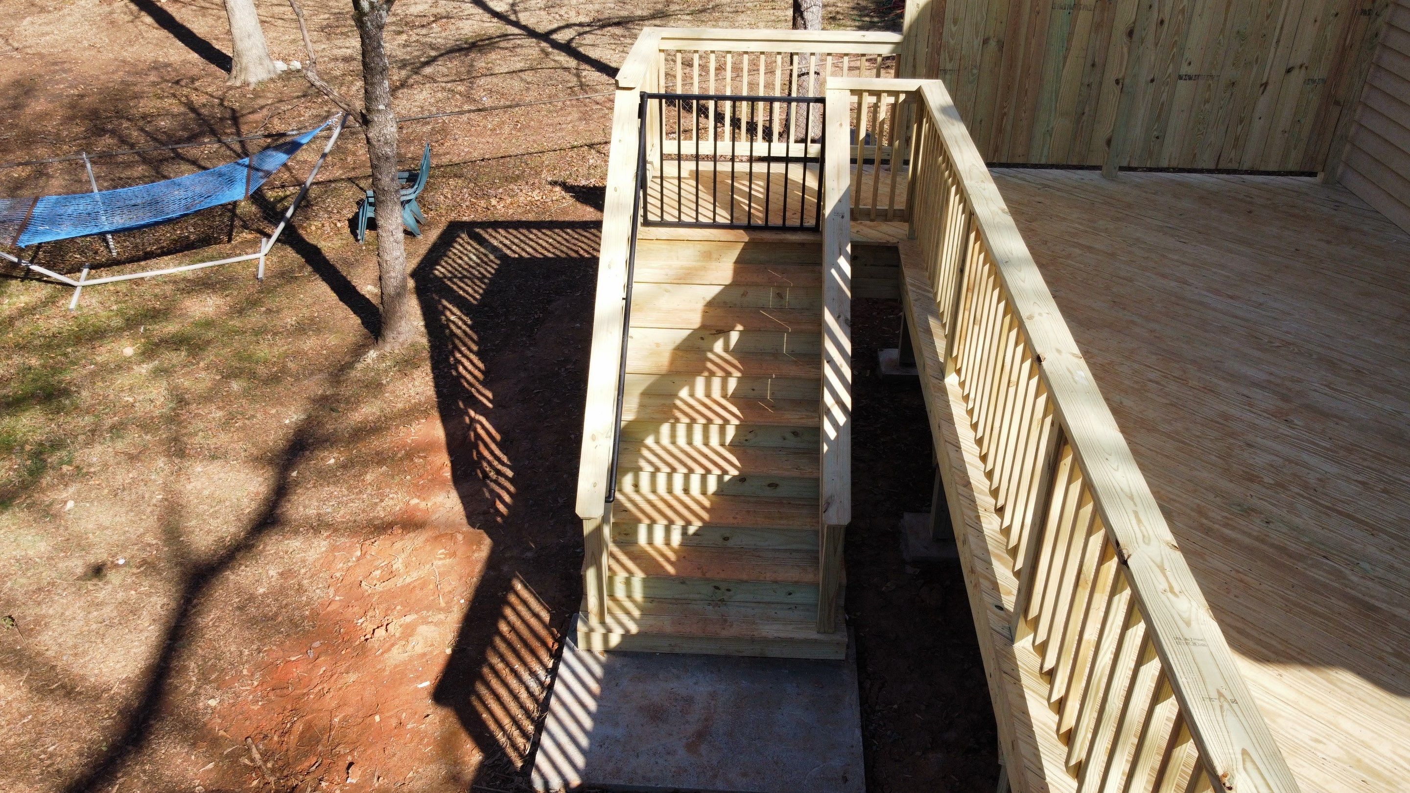 Elevated Pressure-Treated Wood Deck Extension in Marietta by Swift Home Renovations
