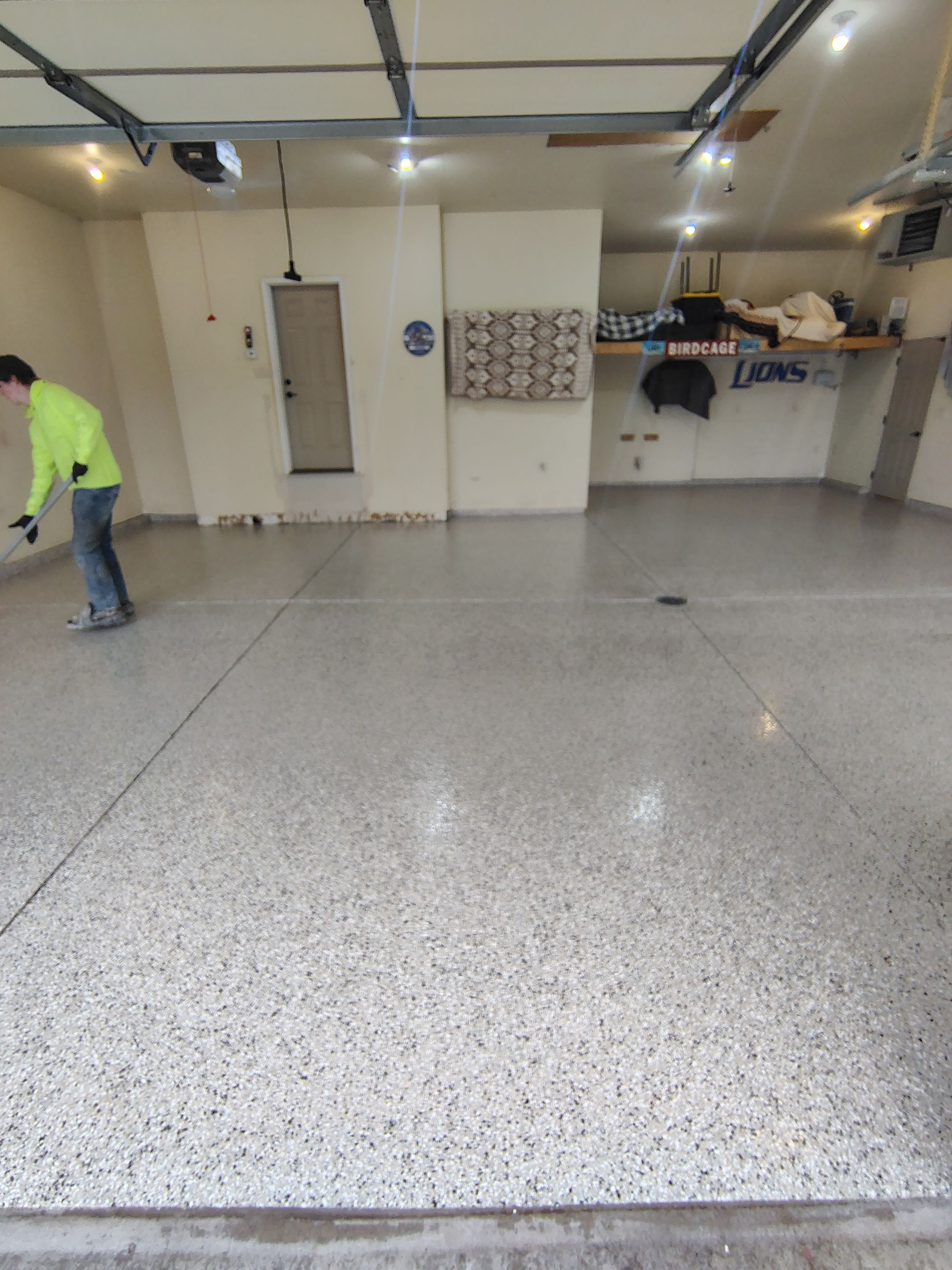 Sioux Falls Garage Floor Repair and Speckled Epoxy Coating Installation by Select Painting, Coatings & Garage Cabinets