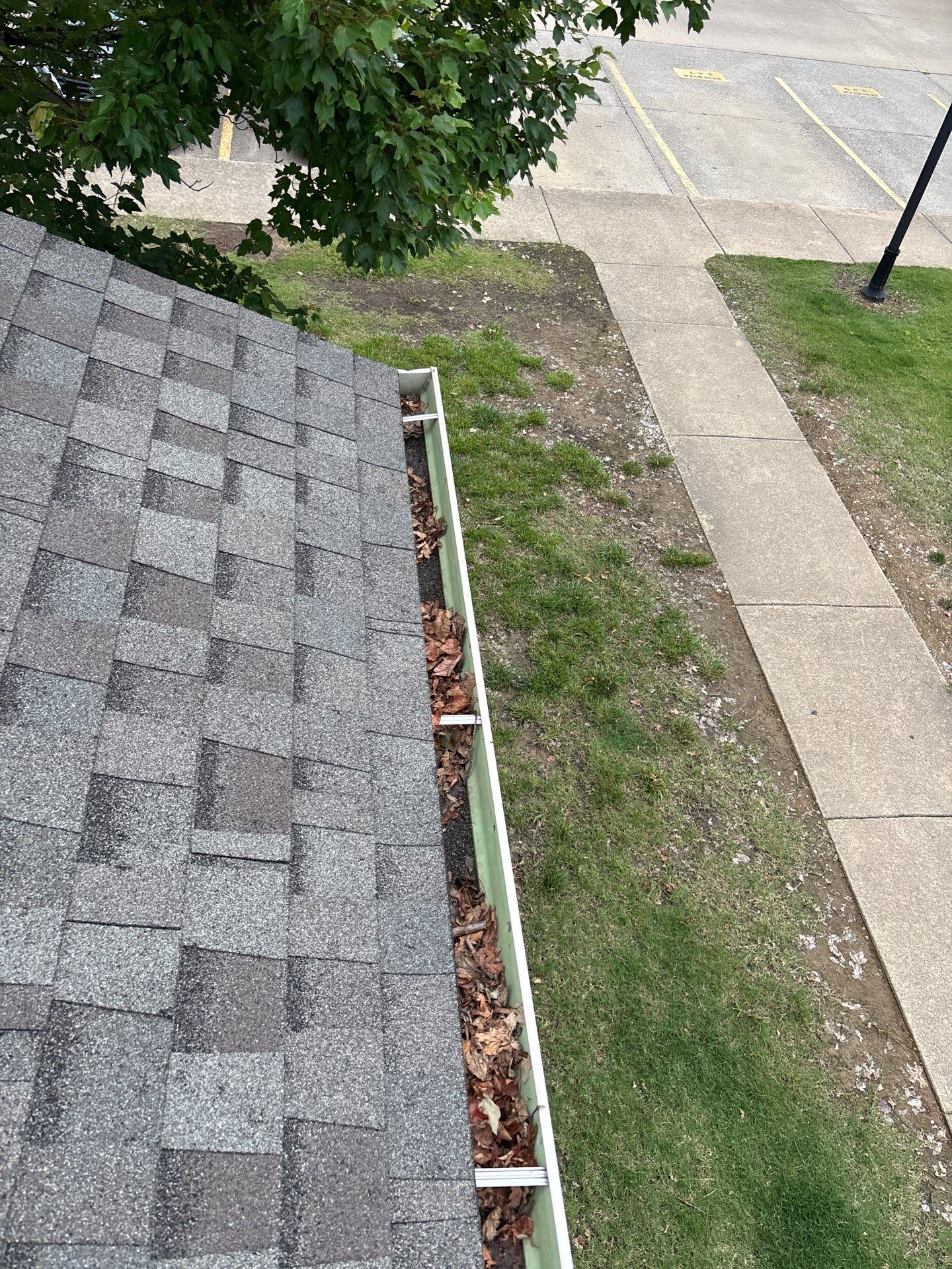 Commercial gutter cleaning Fayetteville before photo with filled gutters