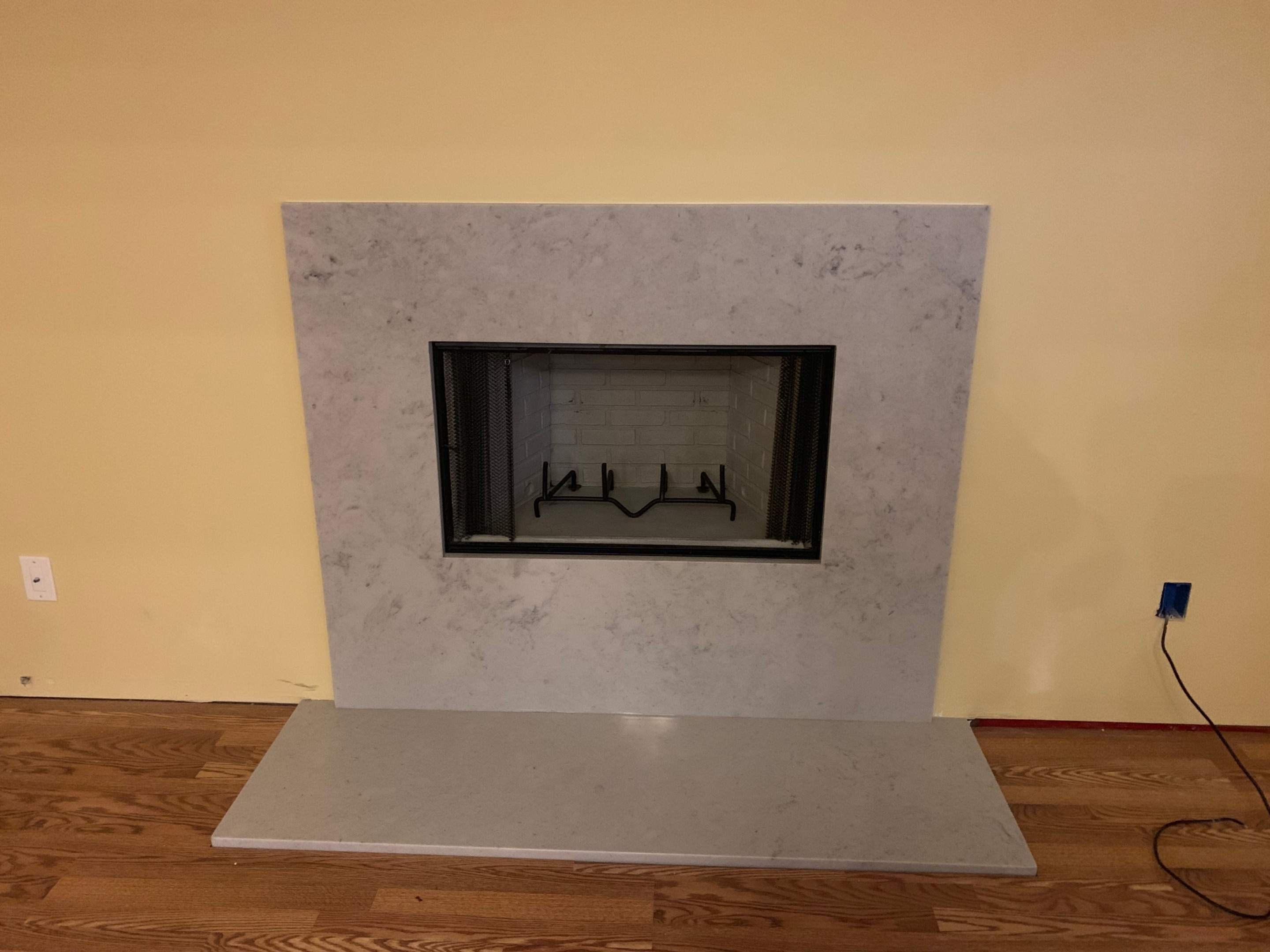 Wood Fireplace + Granite by Premier Chimney and Roofing