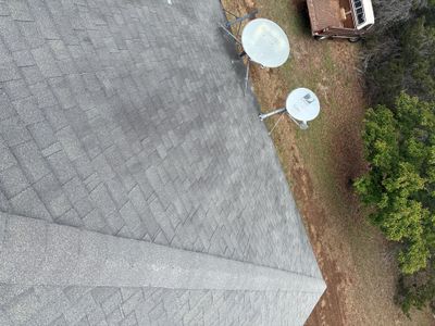 Asphalt shingle roof with two satellite dishes.