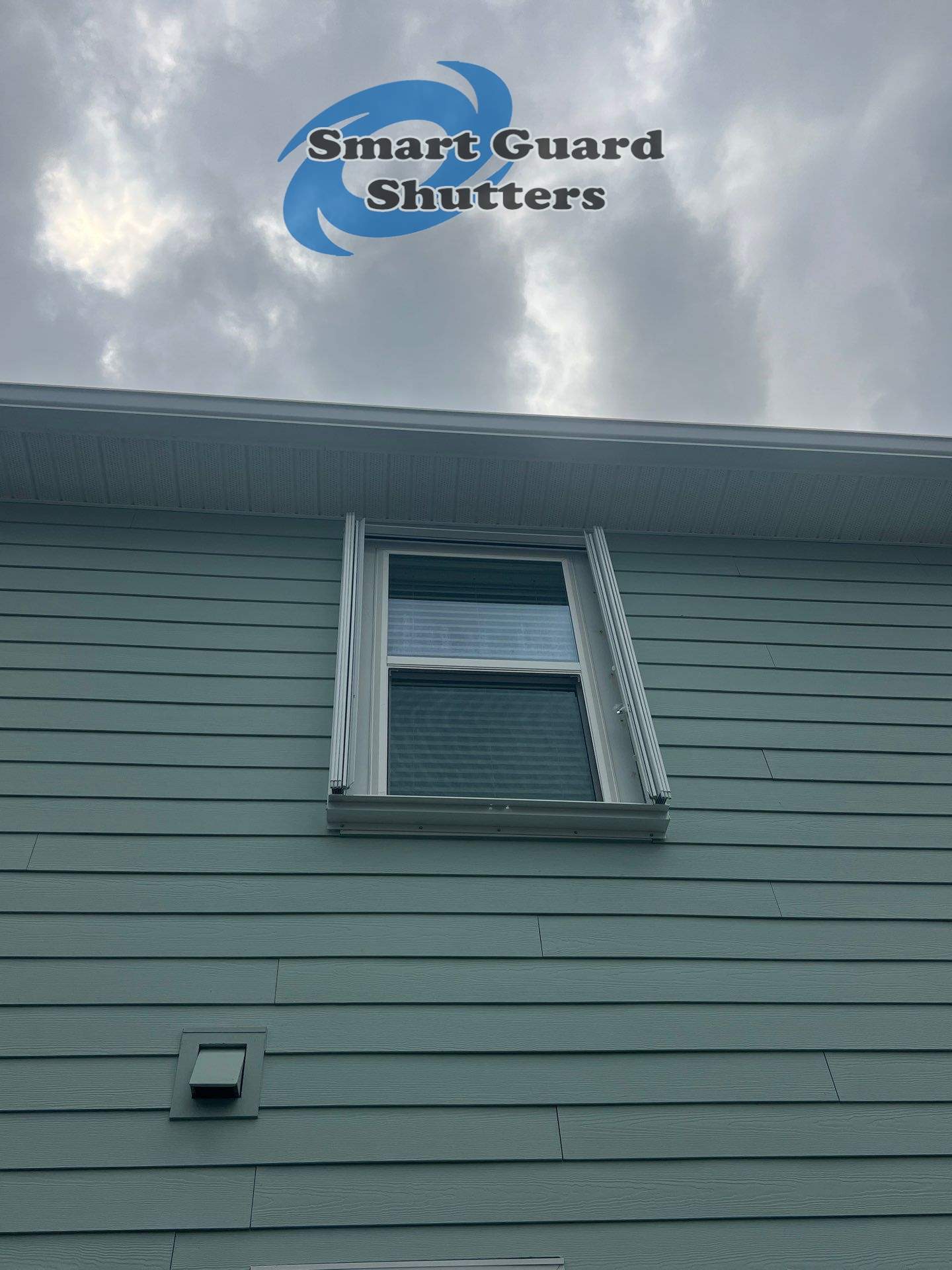 Impact Bahamas in Ocean Blue, Accordion in White by Smart Guard Shutters