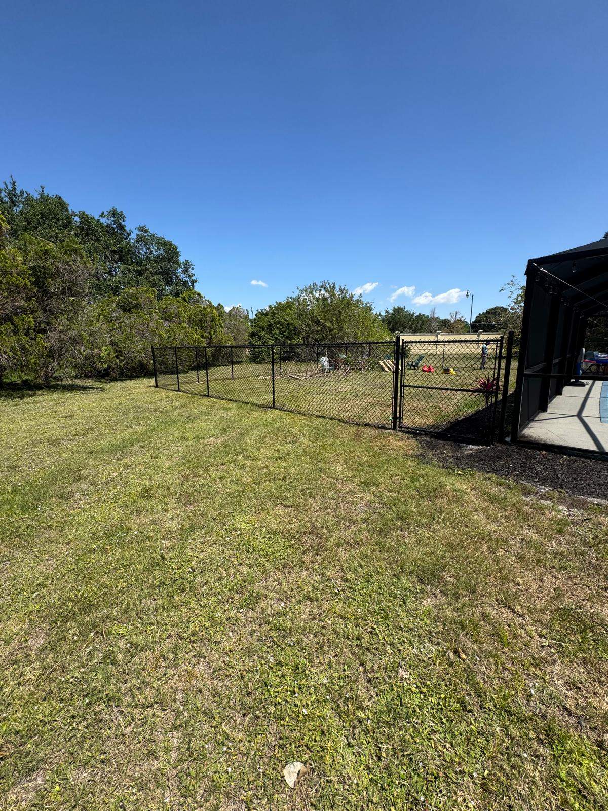 Black Chain Link Residential Backyard Fence Installation in North Port by True Fence LLC