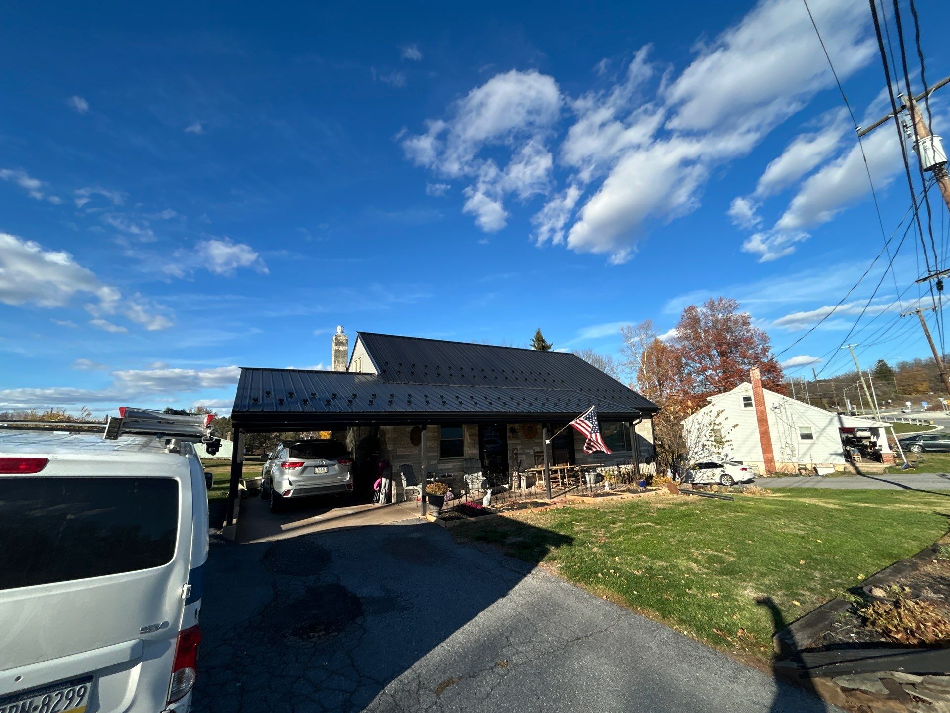 Metal Roofing, Board & Batten Siding, and Entry Door Transformation by Esh Builders