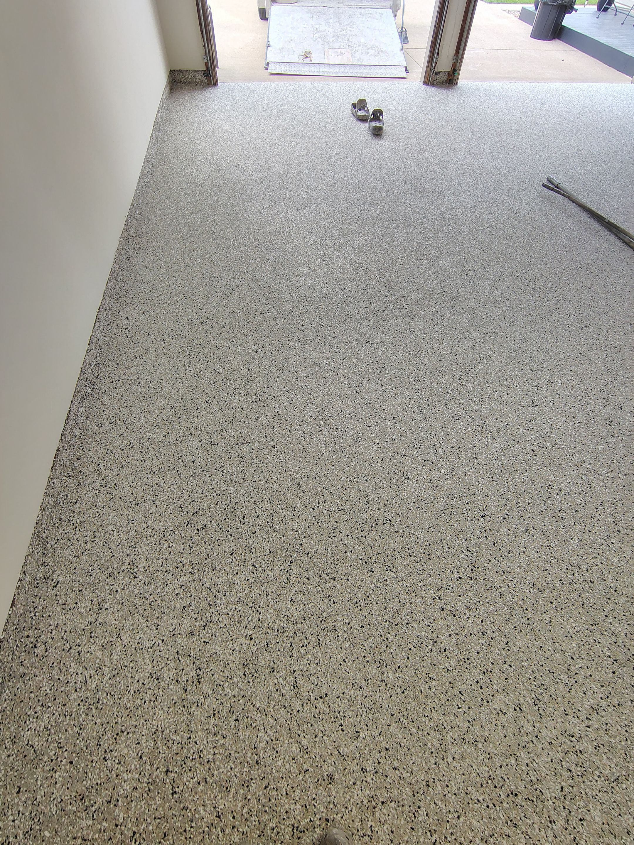 Full-Flake Epoxy Garage Floor Coating Installation in Sioux Falls by Select Painting, Coatings & Garage Cabinets