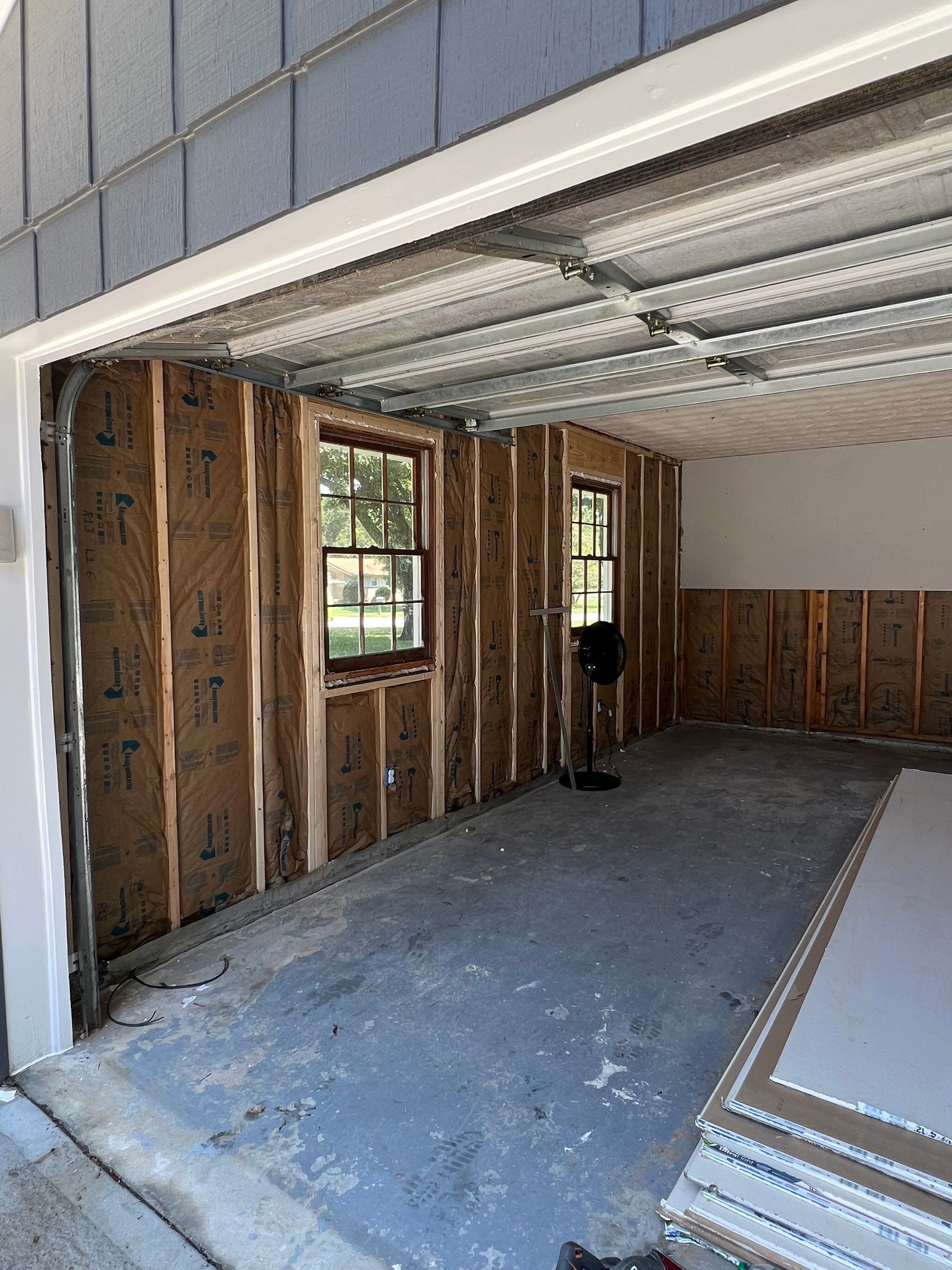 Snellville Garage Remodel Featuring Epoxy Floors and Board and Batten Siding by Swift Home Renovations