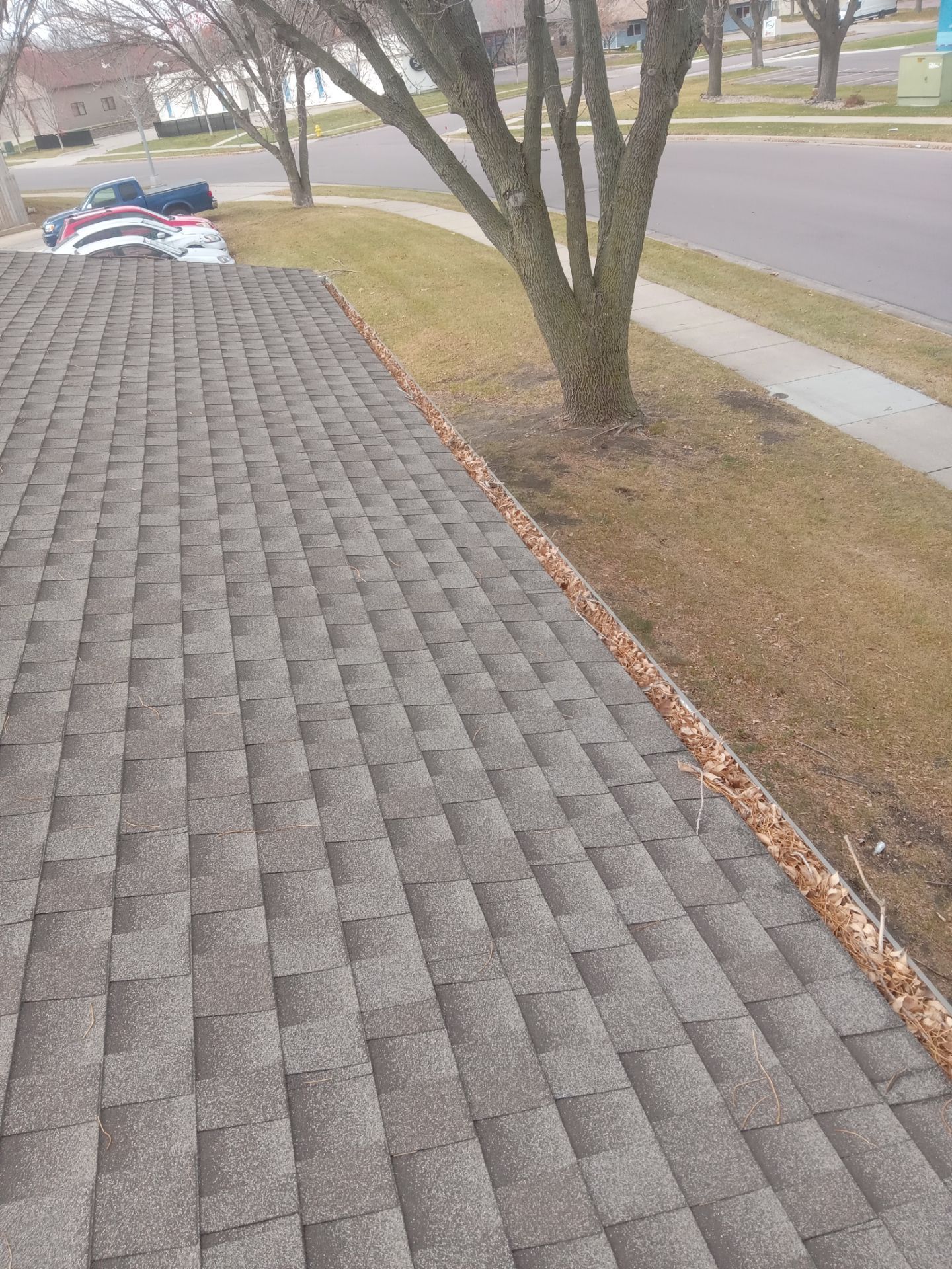 Commercial gutter cleaning Sioux Falls, SD before photo with filled gutters
